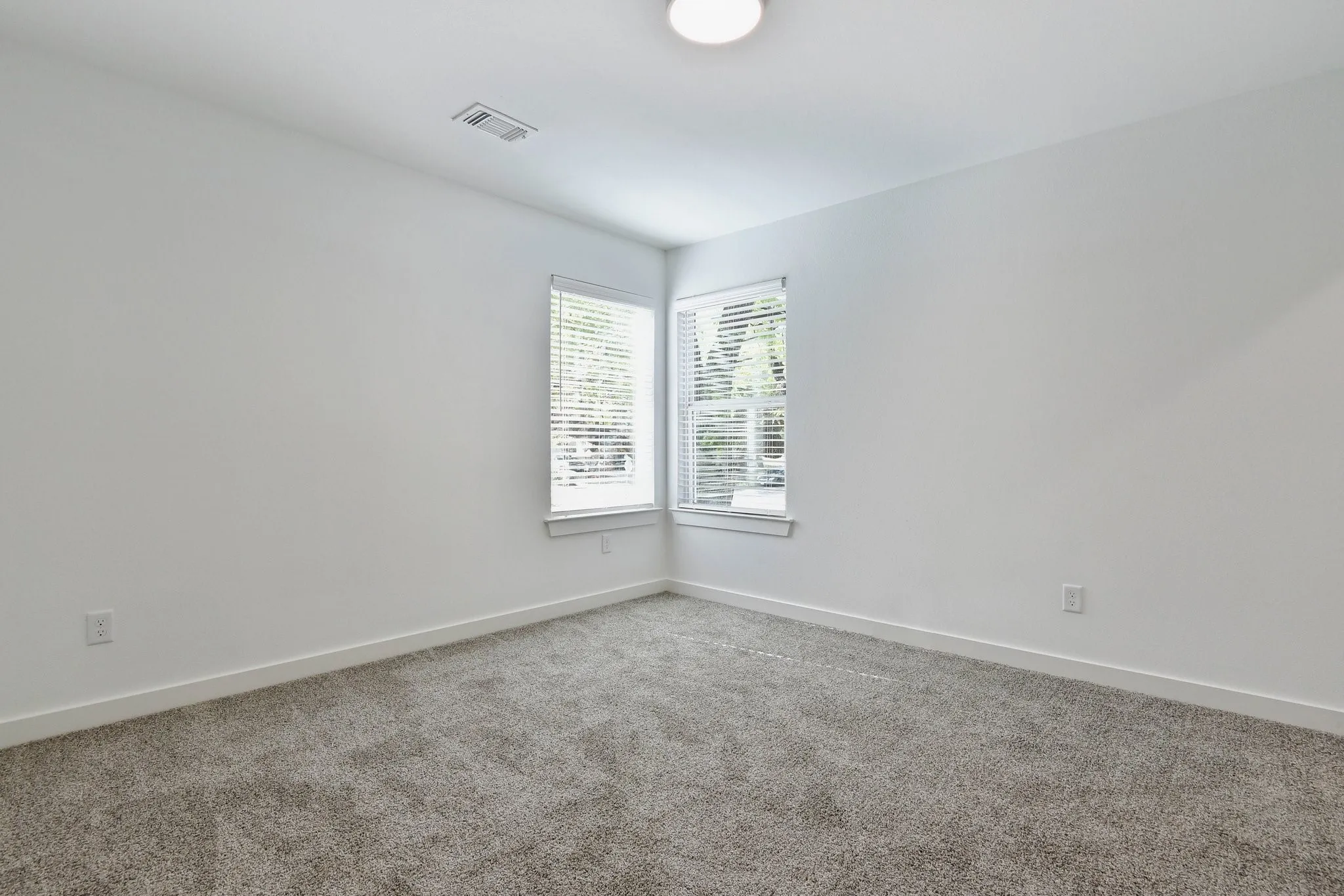 Carpeted spare room with baseboards