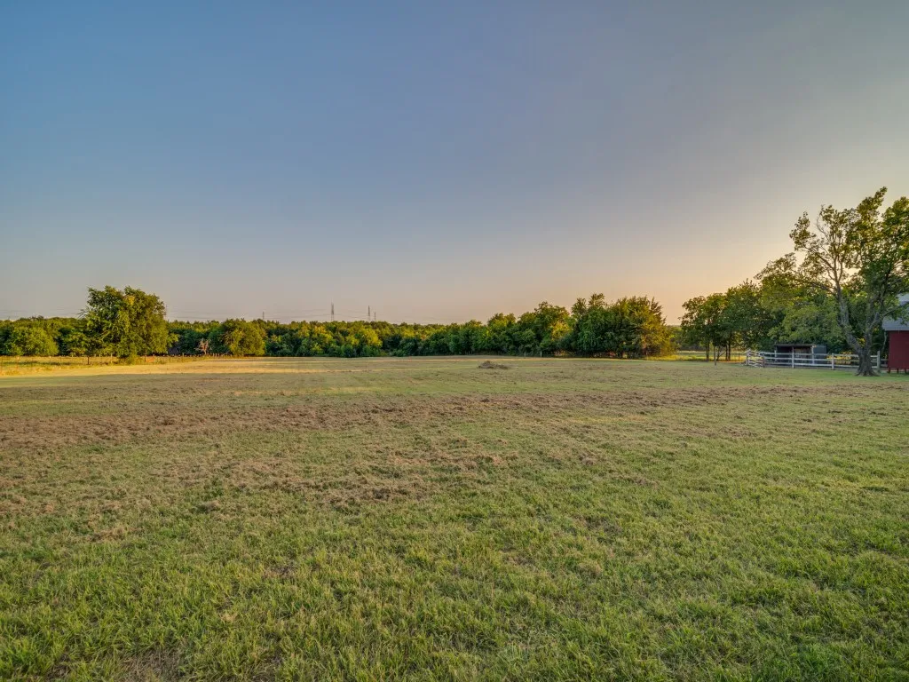 Evening view of the acreage from the fence line as the sun goes down on the horizon.  Picture your horse out in the pasture!