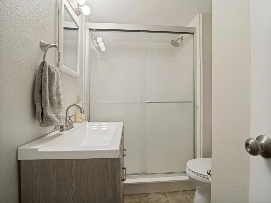 Full bathroom has enclosed shower.