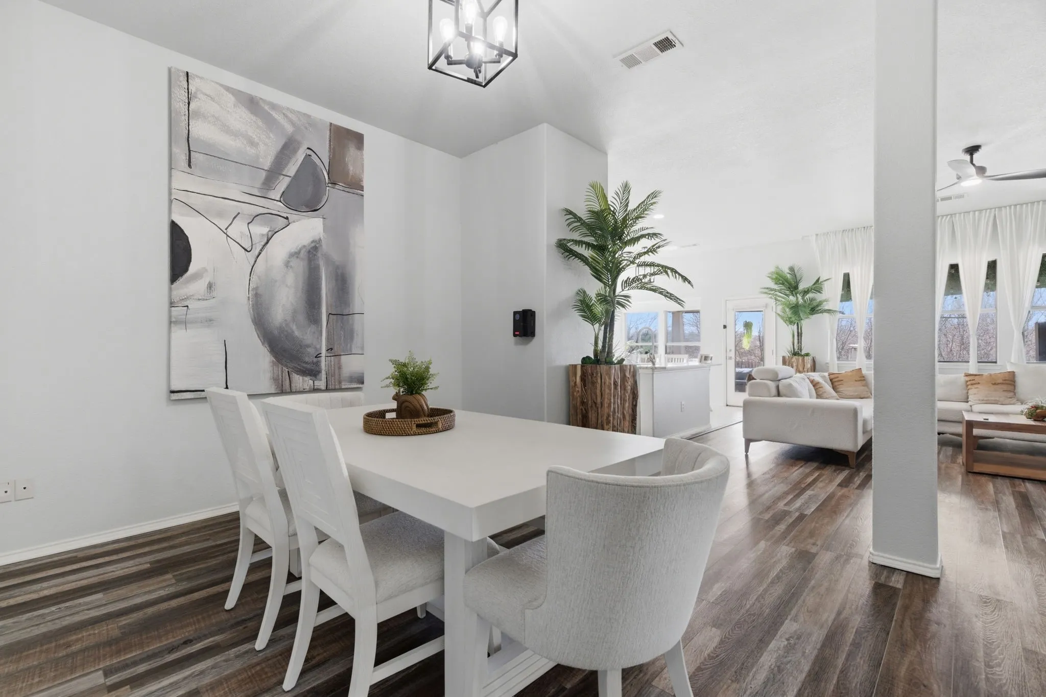 Open-concept living area featuring wood-finish flooring throughout, a vaulted ceiling, and recessed lighting