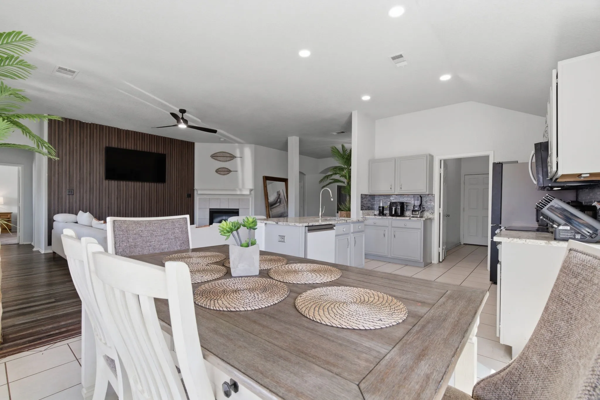 Open-concept living space featuring vaulted ceilings, recessed lighting, and a contemporary ceiling fan