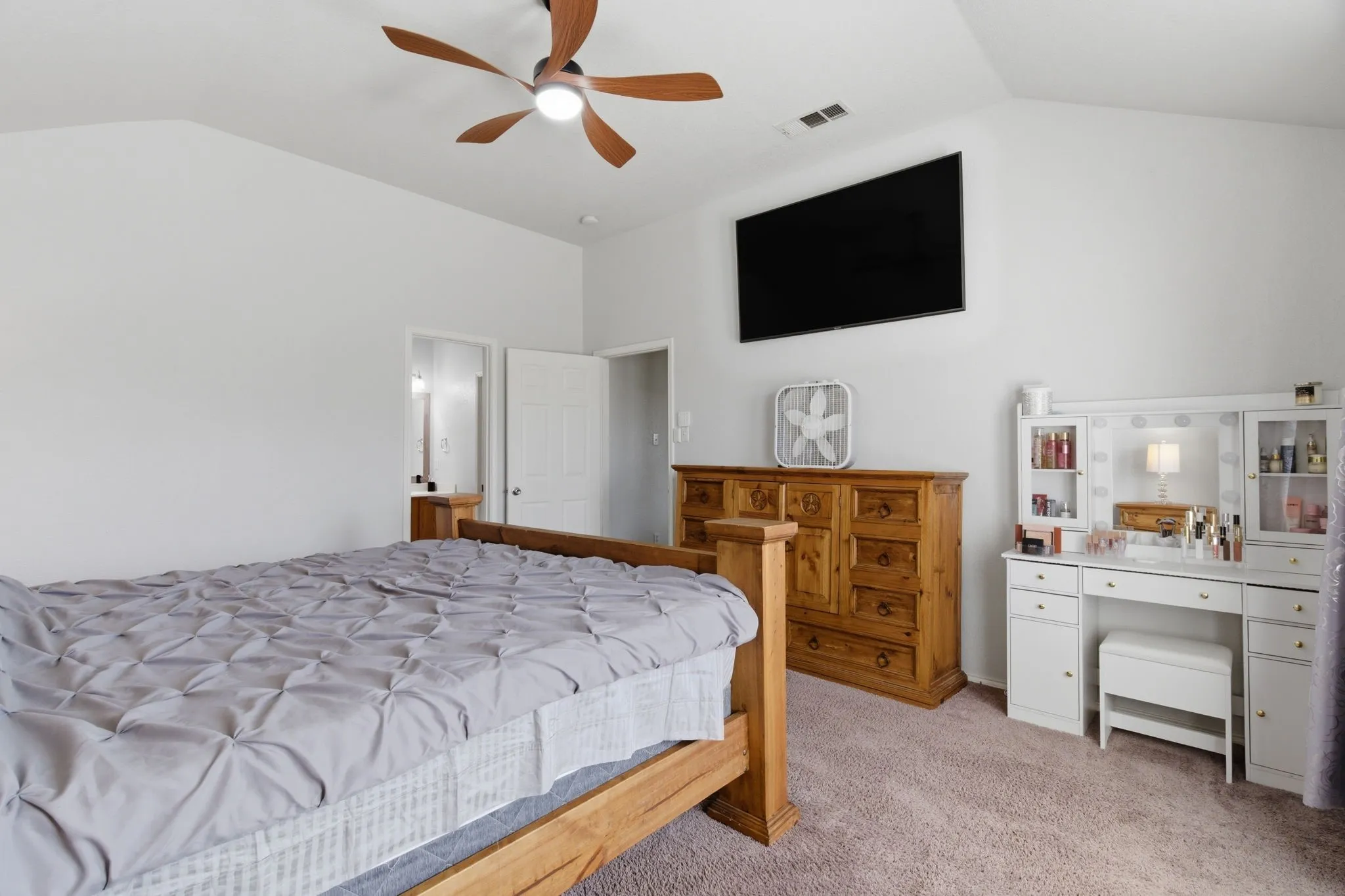 Vaulted ceiling with a wood-finish ceiling fan and light fixture