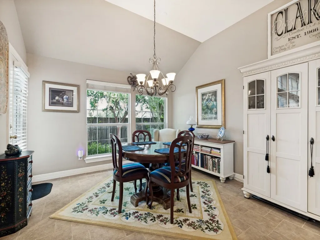 Vaulted ceiling featuring a decorative chandelier