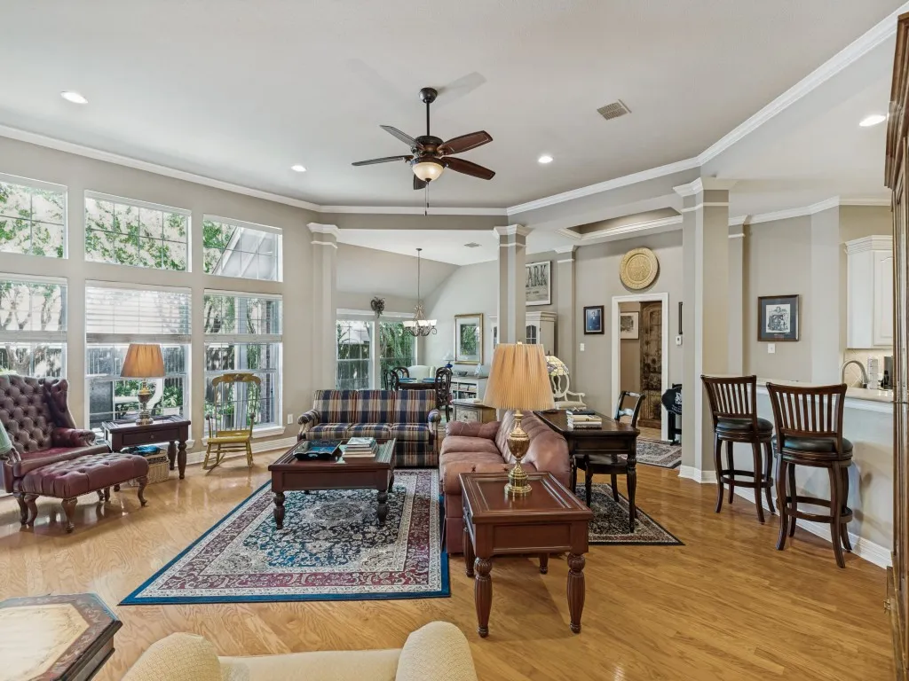 Wood-finish flooring, recessed lighting, and a ceiling fan