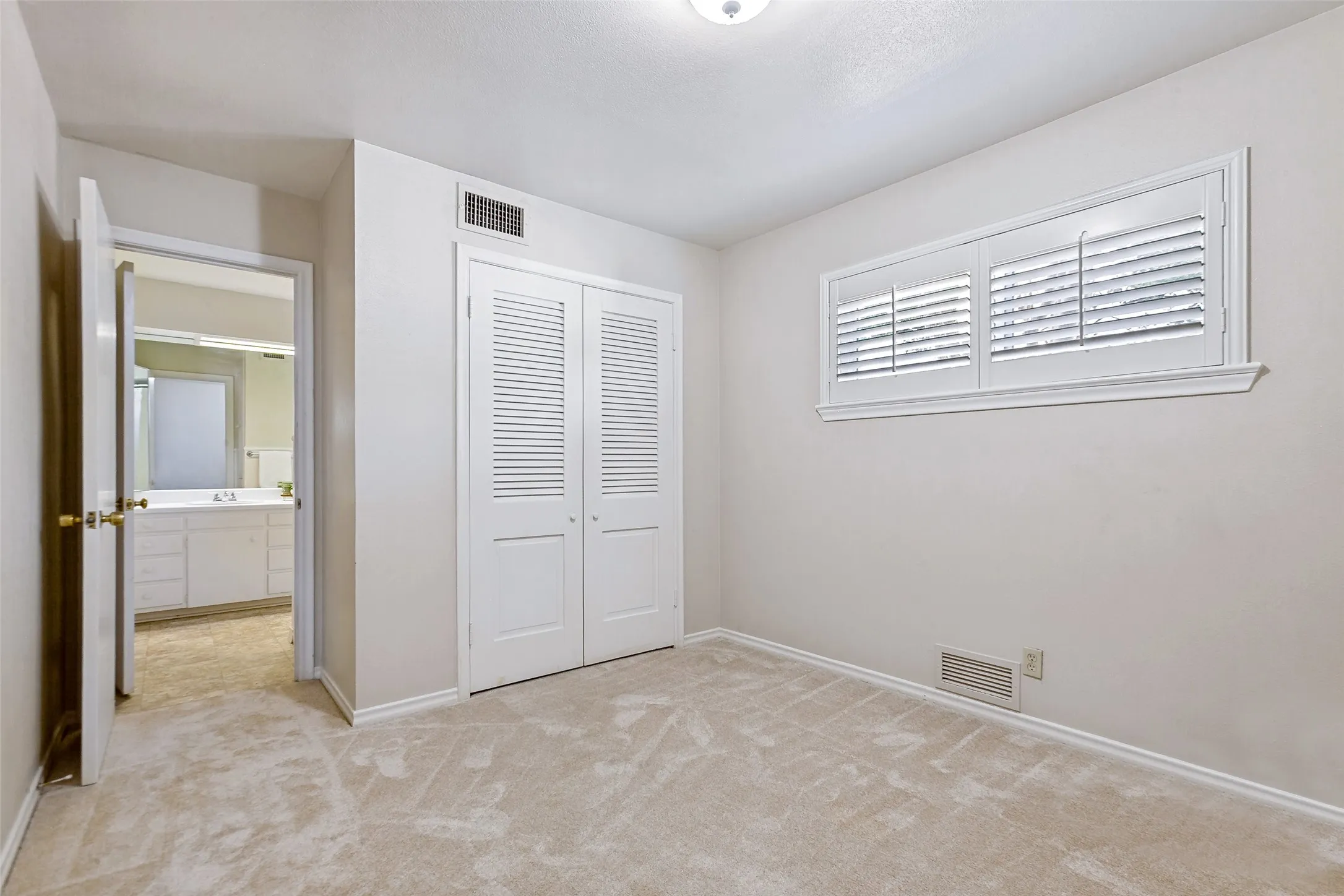Secondary bedroom with shared bath on the first floor.