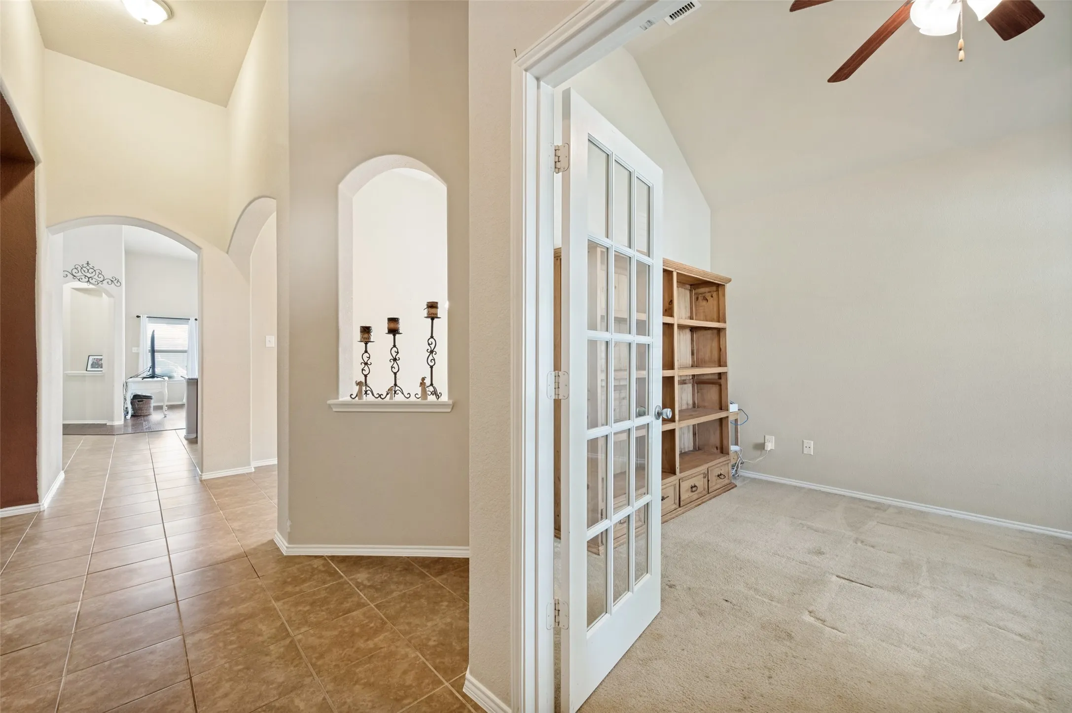 Entryway with arched architectural details and a decorative wall niche