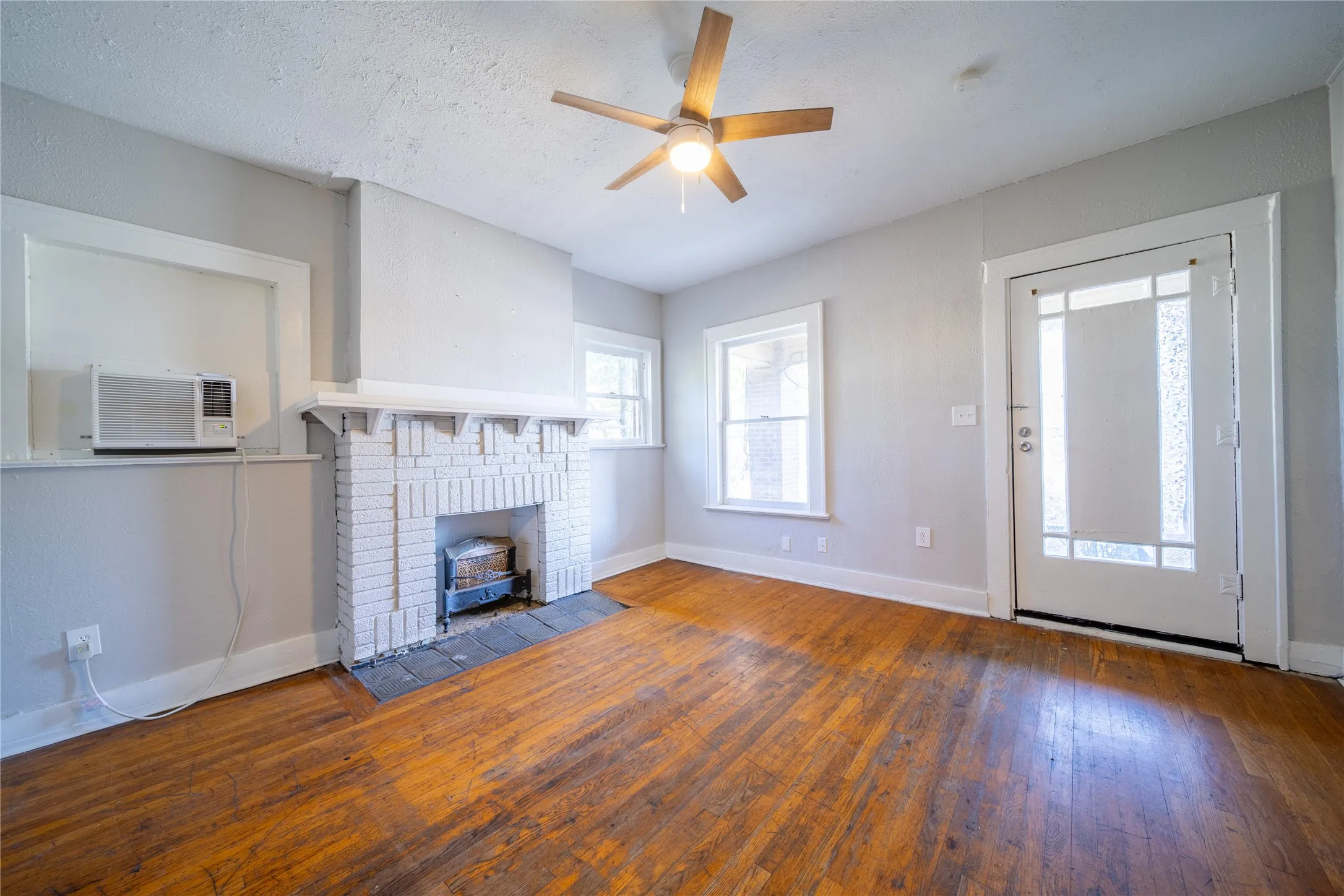 909 Sunset Ave - The living room is located at the front of the home. The door in the photo is entrance from the front porch.  The fireplace is decorative.