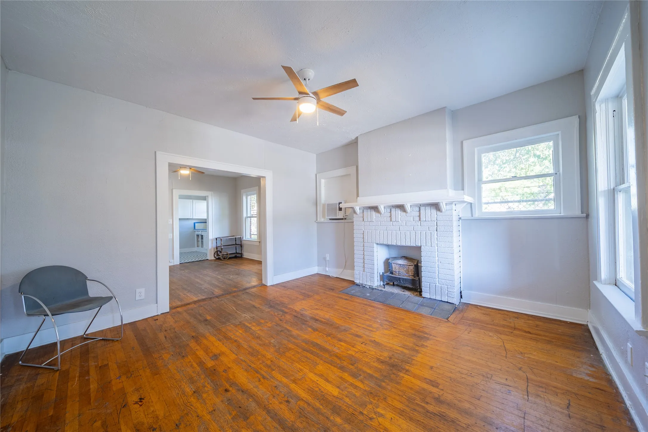 909 Sunset - The renovated first floor living room, located at the front of the room opens to the dining room.