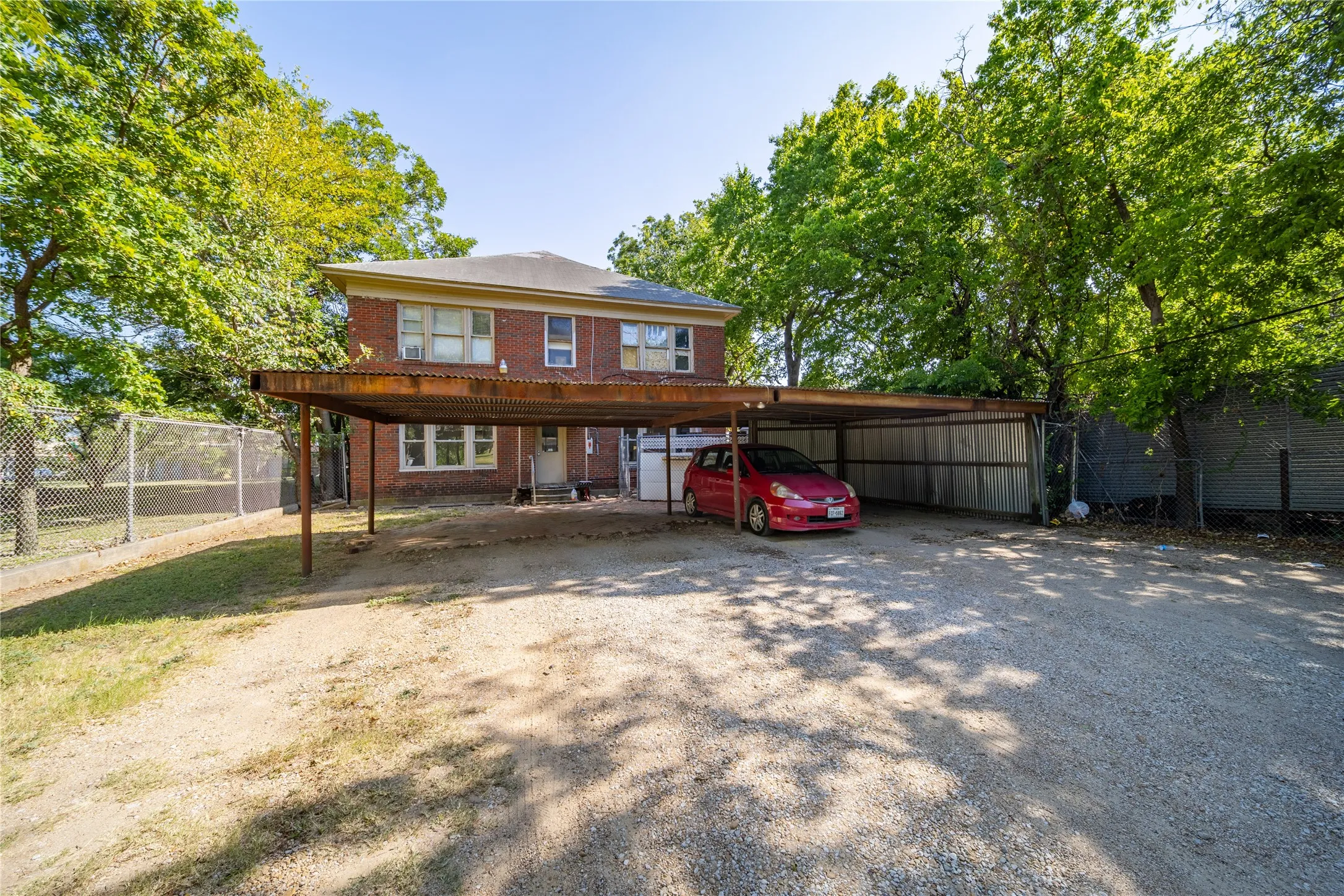 909 Sunset Ave - The carport with 4 parking spaces, one for each unit, is located at the back of the property and is accessed from the alley. There is also a common entrance to all units in the back of ghe building.