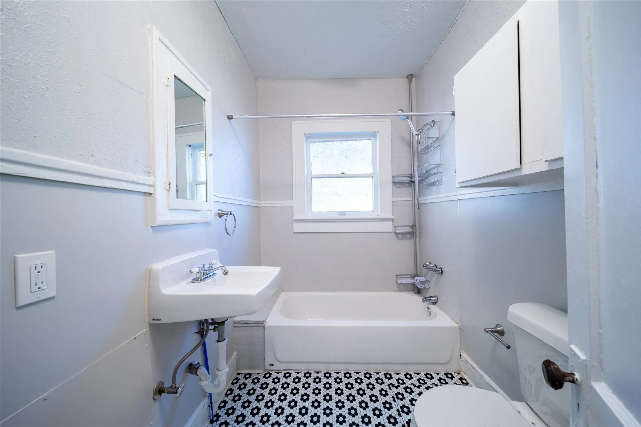 909 Sunset - The renovated bathroom on the first level is located at the end of the hallway just off of the bedroom.