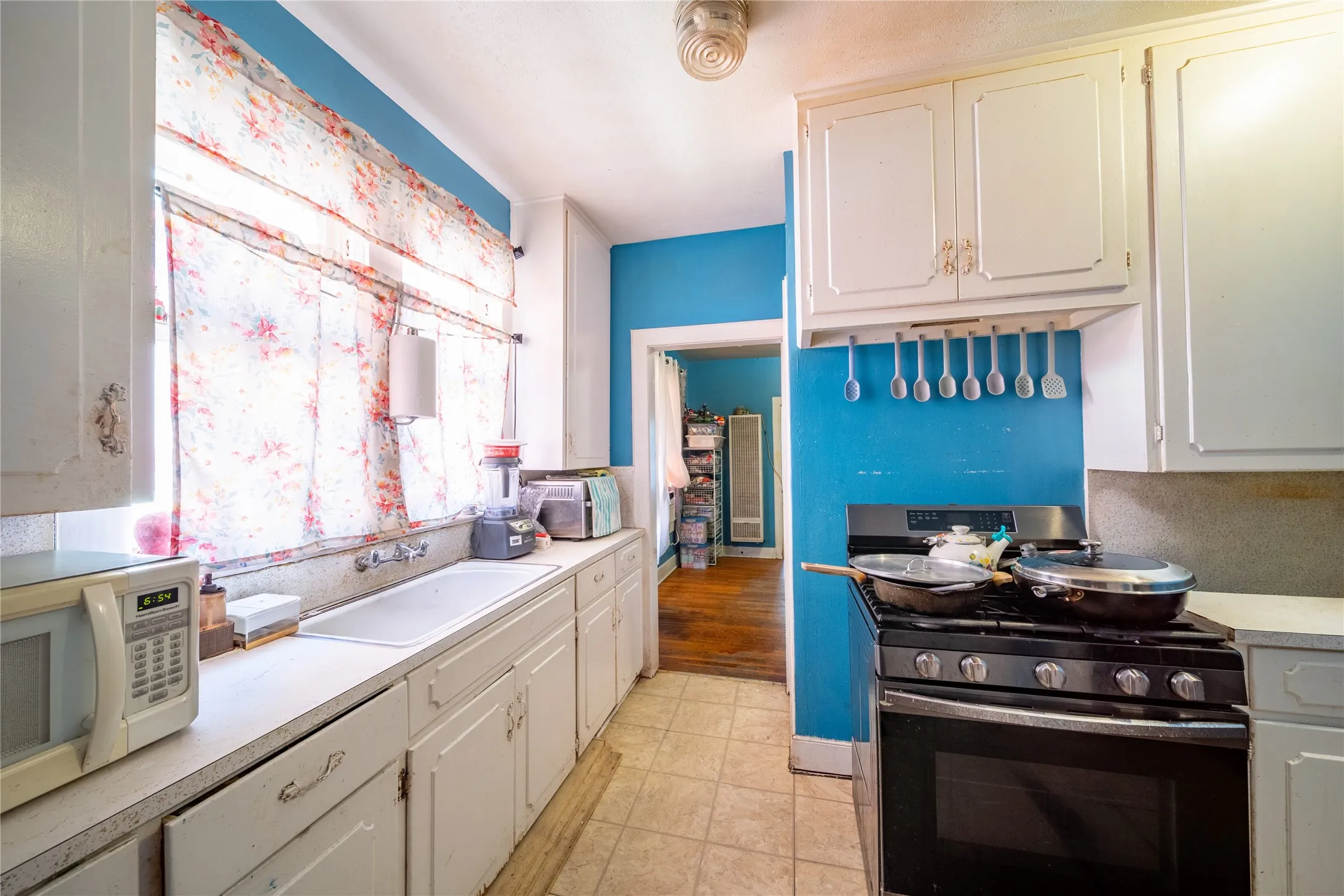921 Sunset. The galley kitchen connects to the dining room and leads to the bedroom located at the back of the home.
