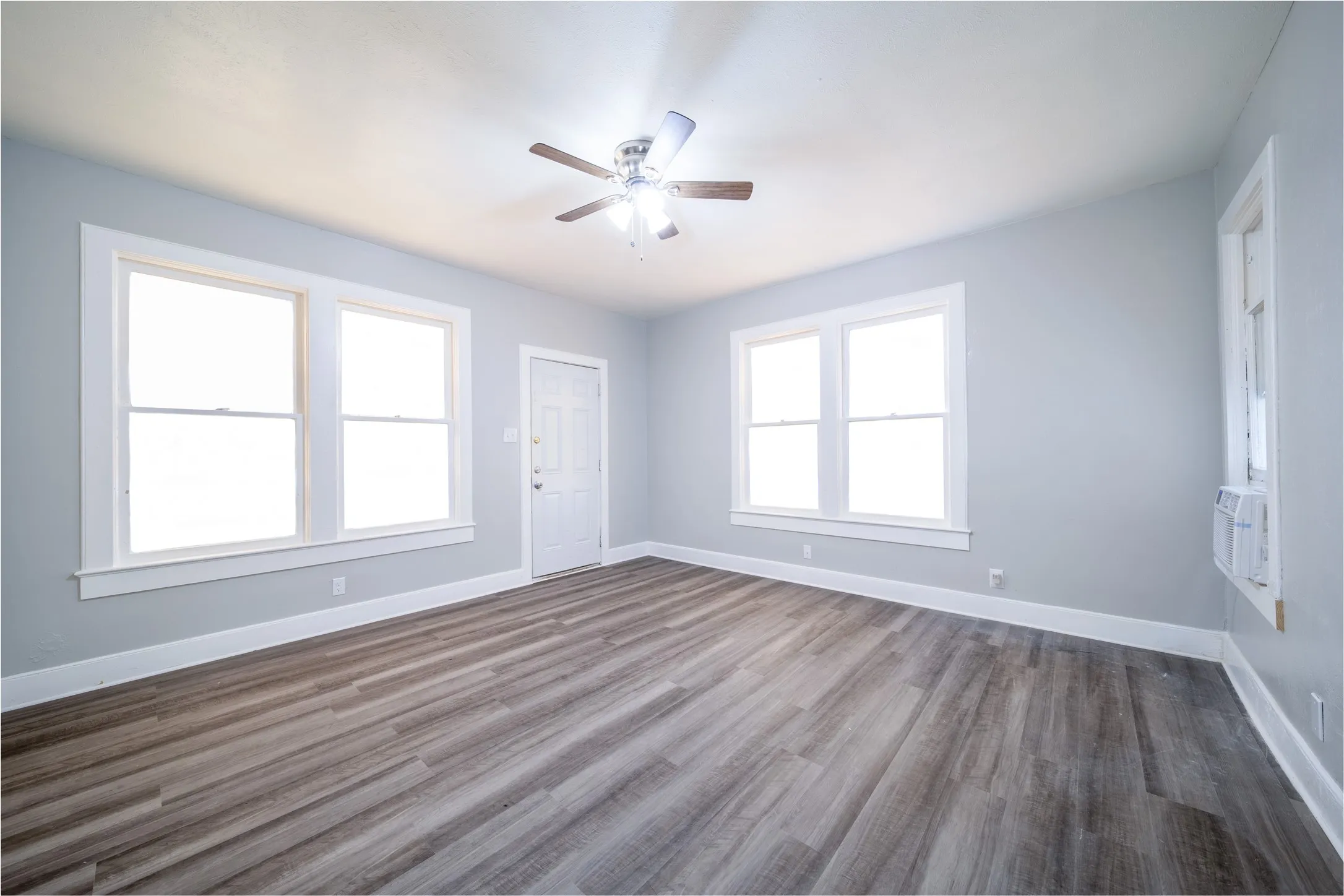 923 Sunset. The front entrance door is located in the center of the picture.  The room has views to the front yard and the side driveway.