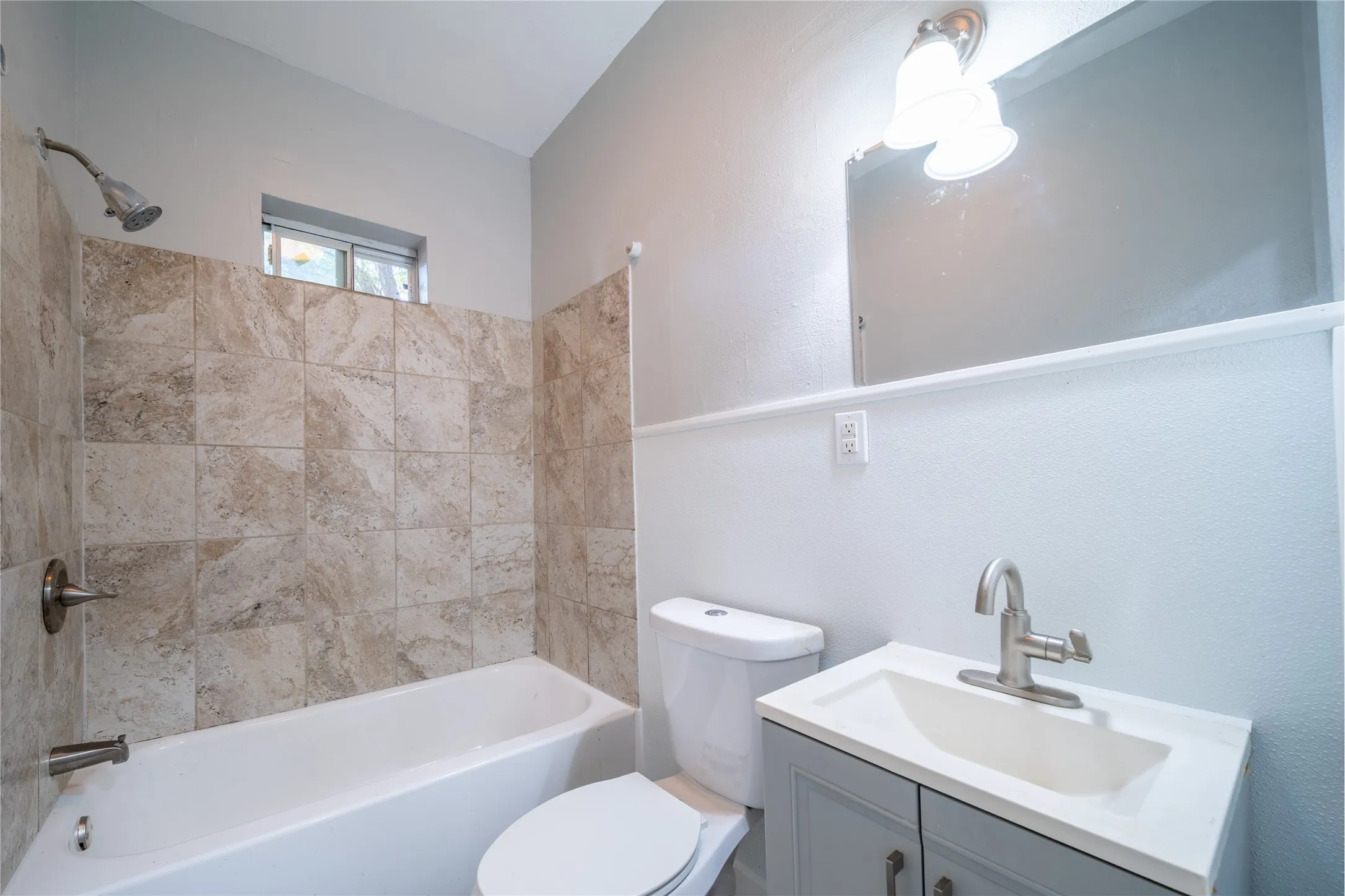 923 Sunset. The bathroom is located at the end of the hallway and next to the bedroom - located at the back of the house.