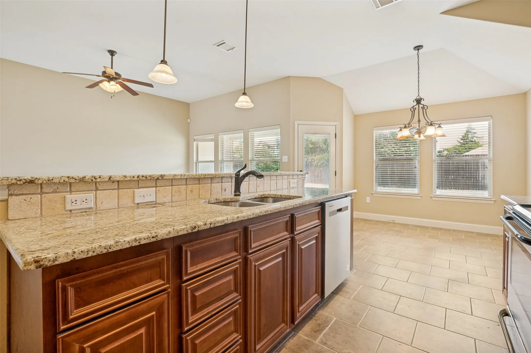 Kitchen island with granite countertop and tile backsplash