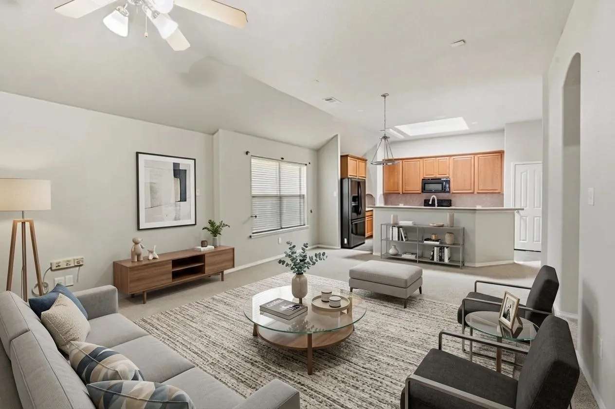 Open-concept living space featuring carpet flooring and light-toned walls