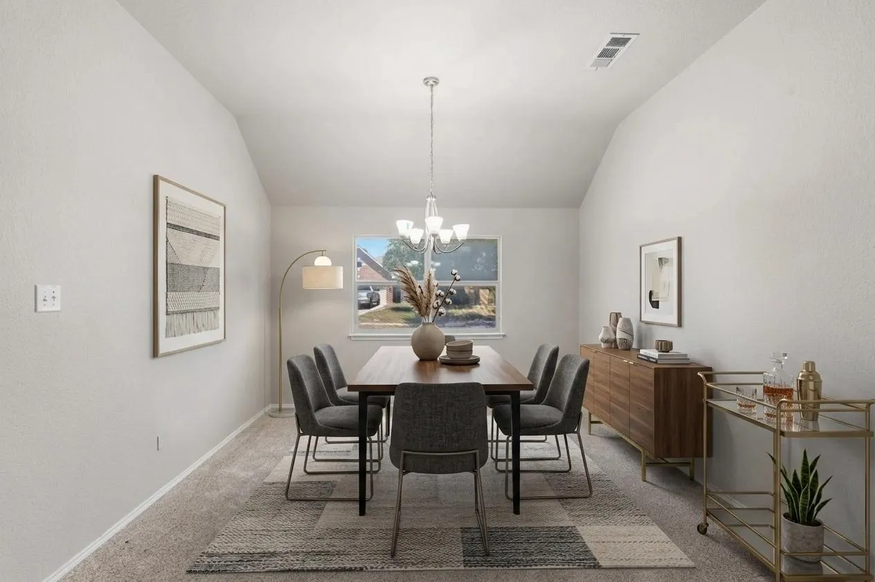 Dining area featuring vaulted ceilings, a central window, and recessed lighting