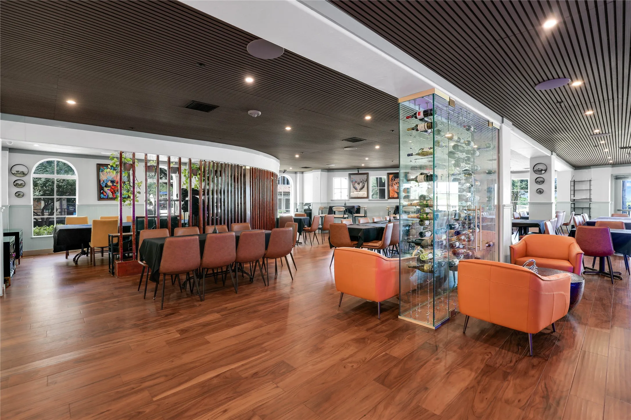 Spacious interior featuring wood-finish flooring, a contemporary slatted ceiling, and recessed lighting