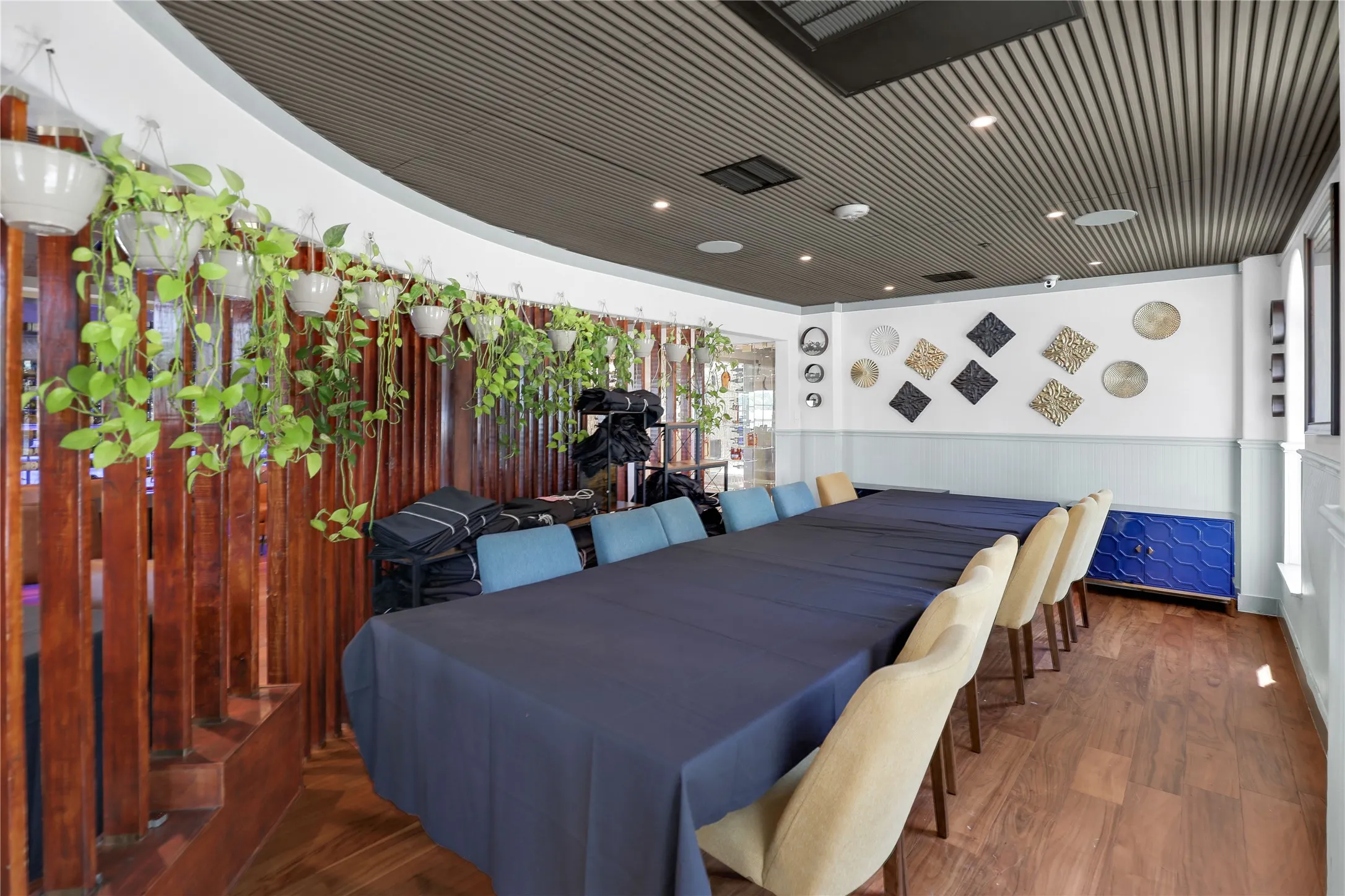 Spacious gathering area featuring wood-finish flooring and a slatted wood ceiling