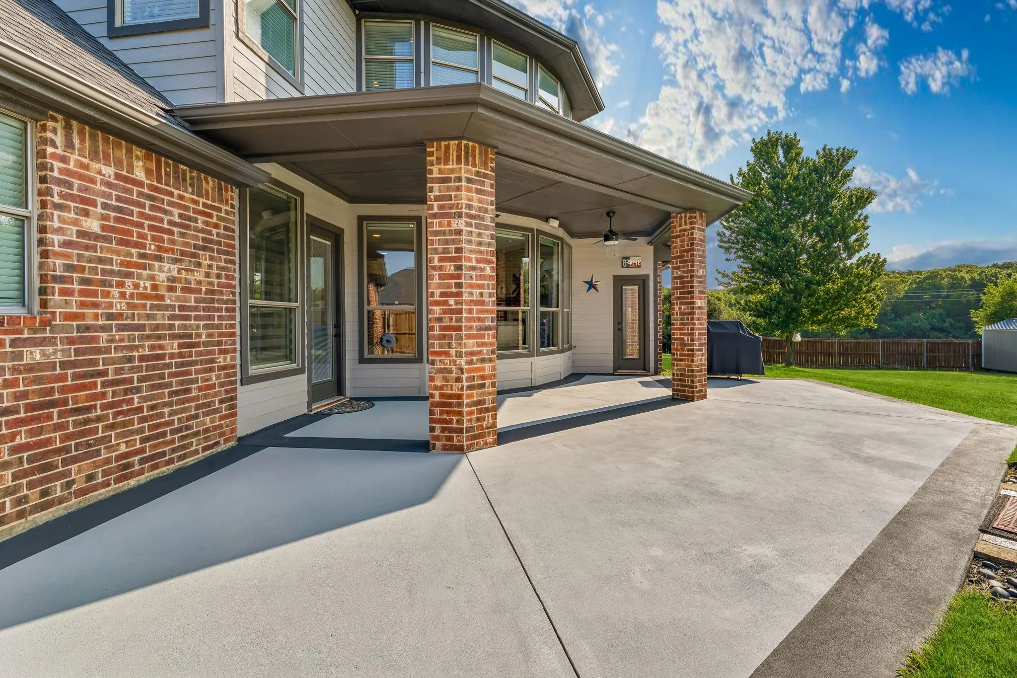 Covered and open patio space over looking the pool and back yard.