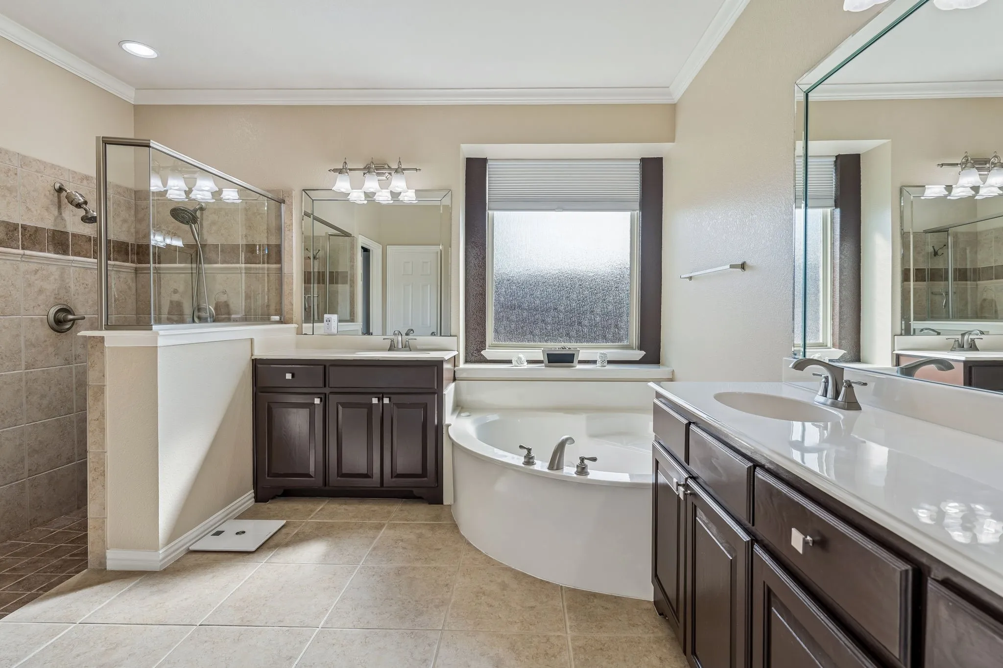Primary bathroom with separate shower, jetted tub and separate sinks.