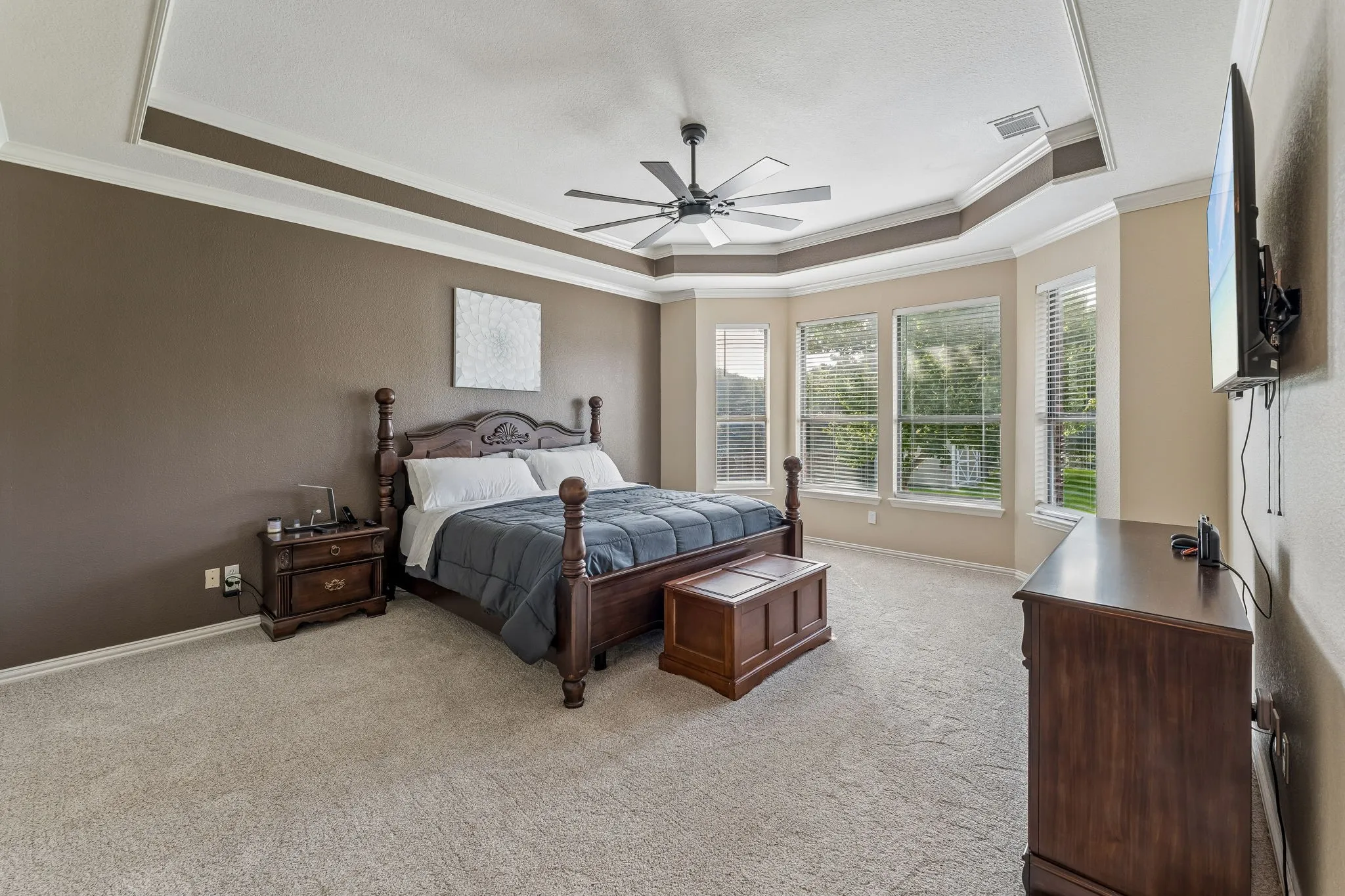 Large primary bedroom with bay window.