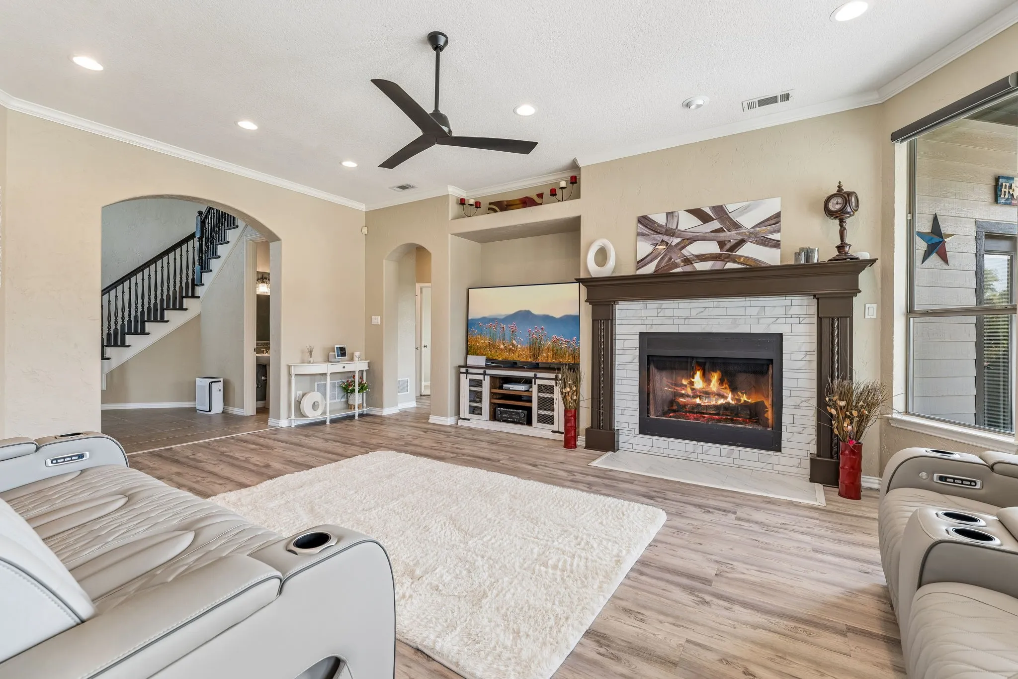 Living room with gas log fireplace and veiw of entry way.