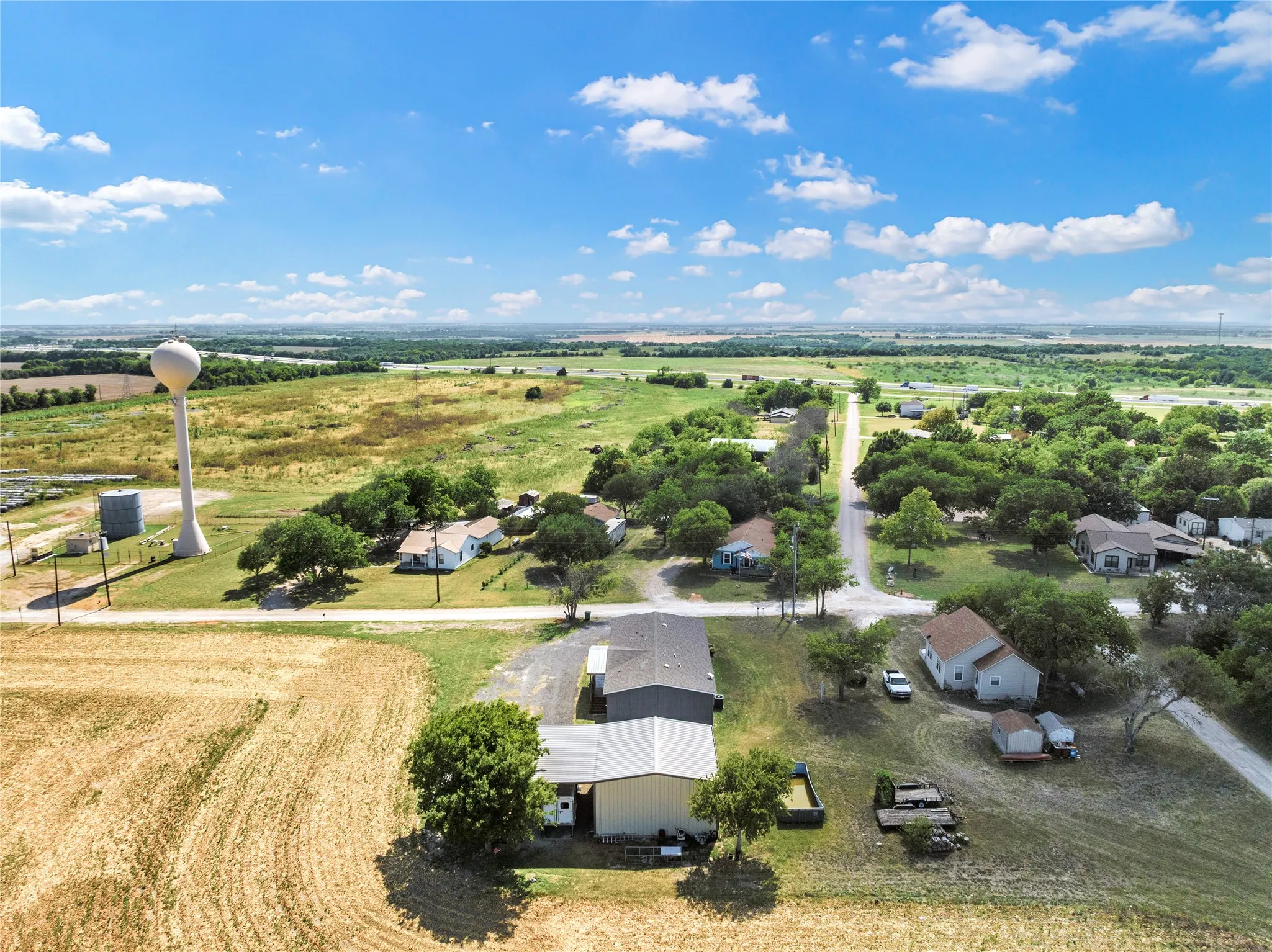 Expansive rural landscape featuring a water tower and agricultural fields
