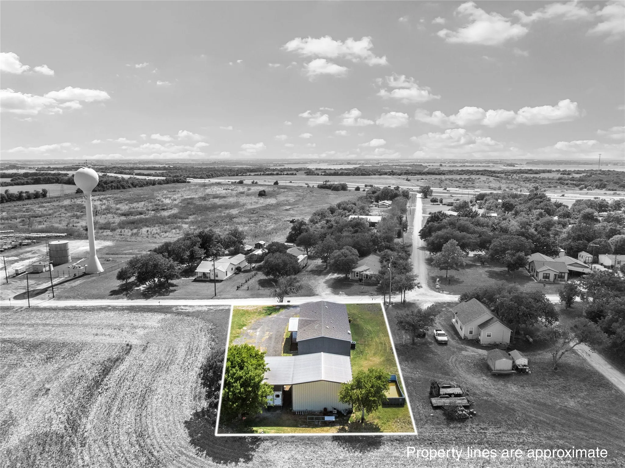 Aerial overview of the property featuring a main building with an attached covered structure