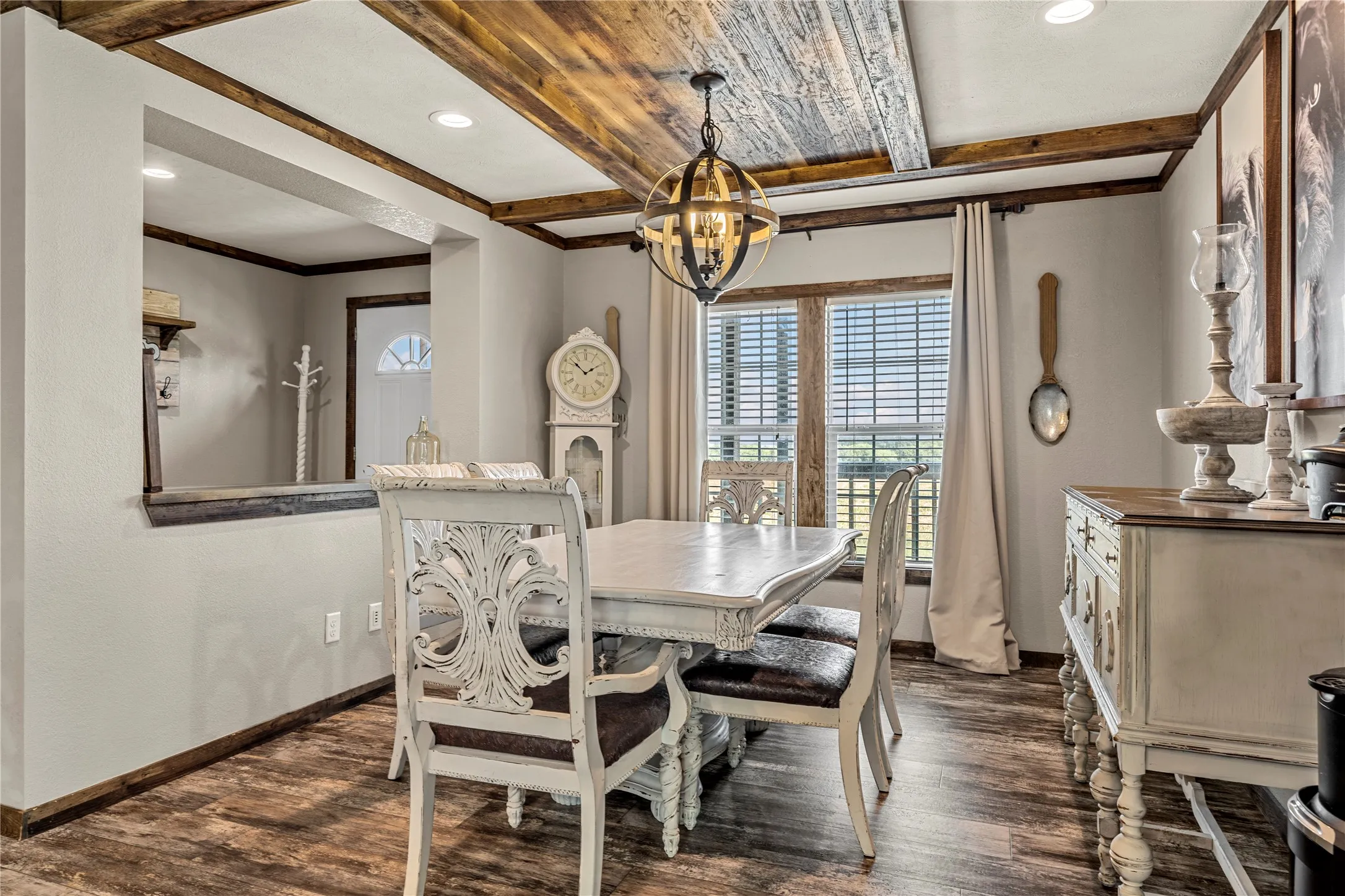 Dining area featuring wood-finish flooring and a decorative wood ceiling with exposed beams