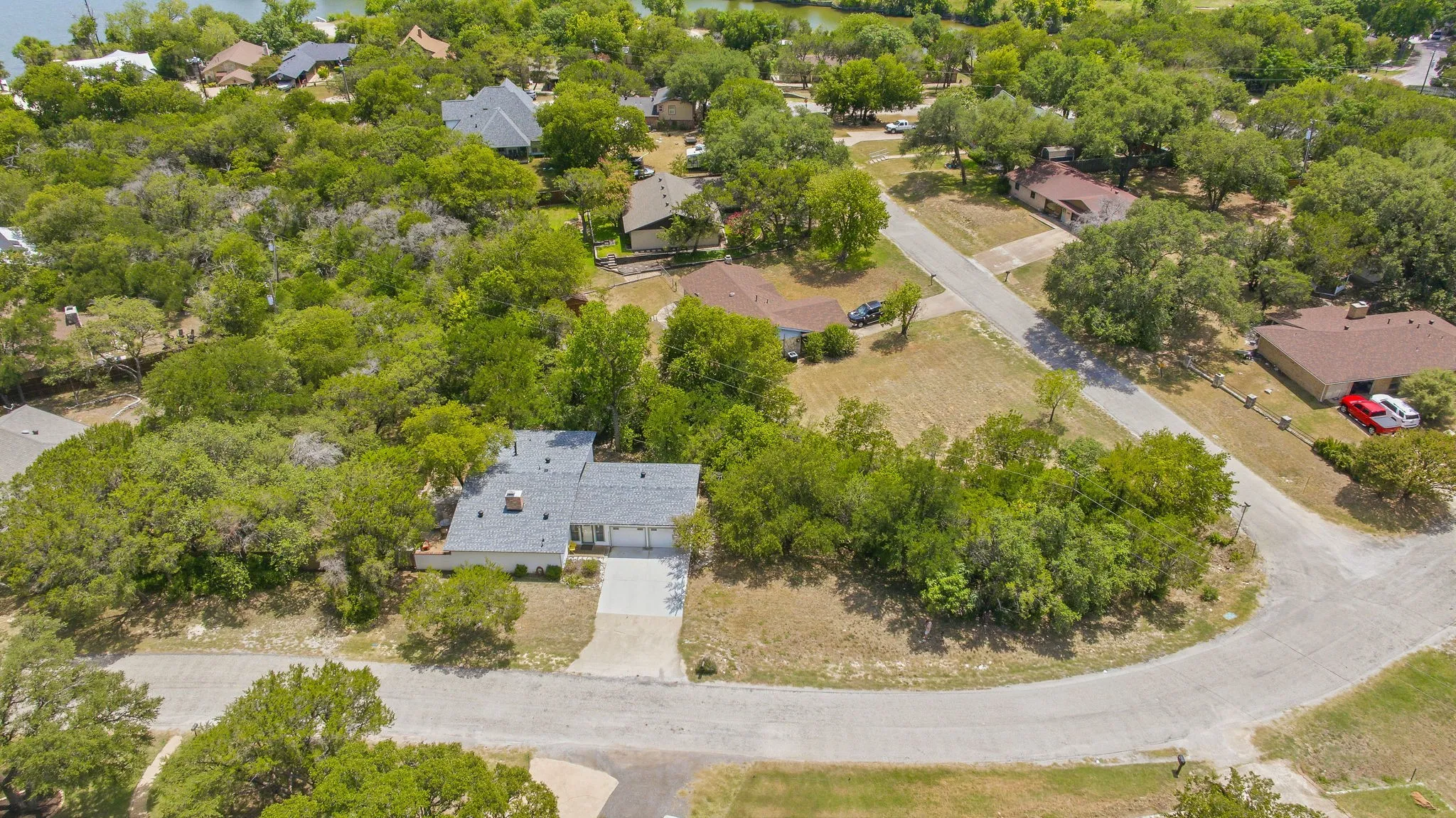 Single-story residence featuring a two-car garage and a paved​​‌​​​​‌​​‌‌​‌‌​​​‌‌​‌​‌​‌​​​‌​​ driveway