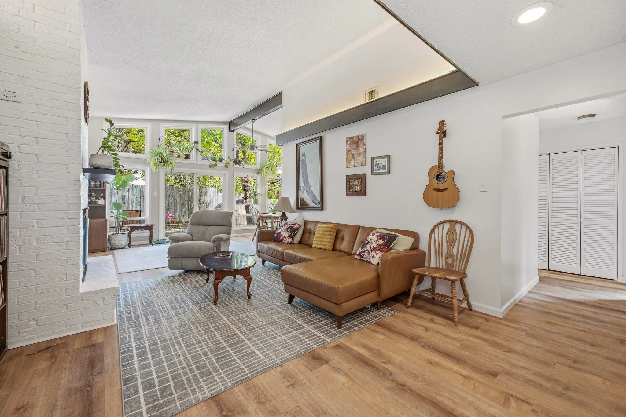 Open concept living area featuring a vaulted ceiling with recessed lighting