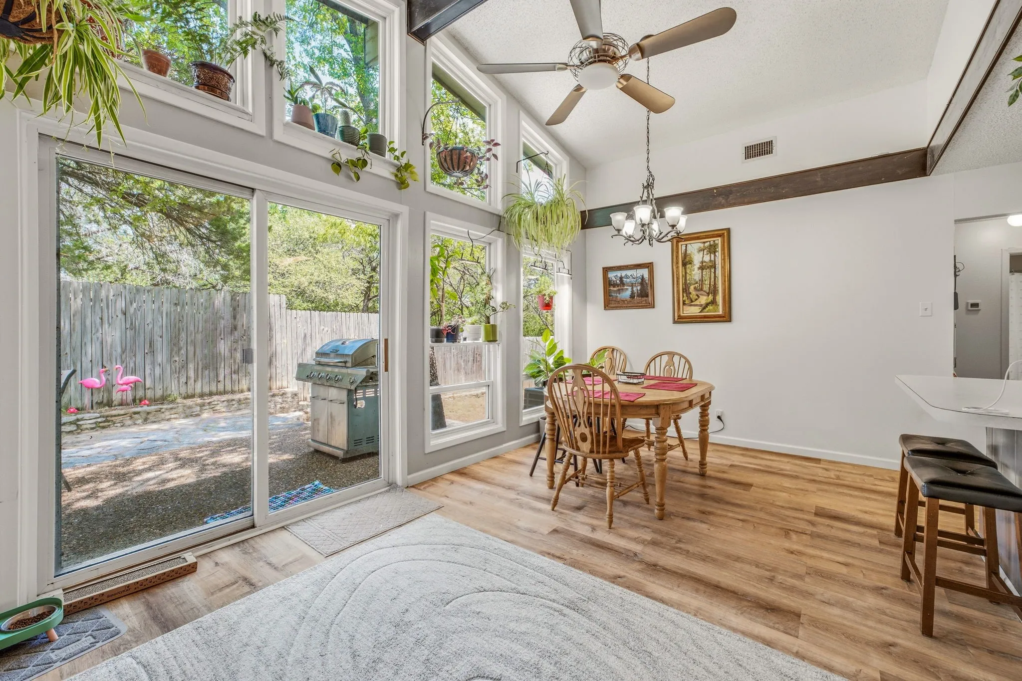 Spacious interior with vaulted ceilings, wood-finish flooring, and a prominent exposed beam