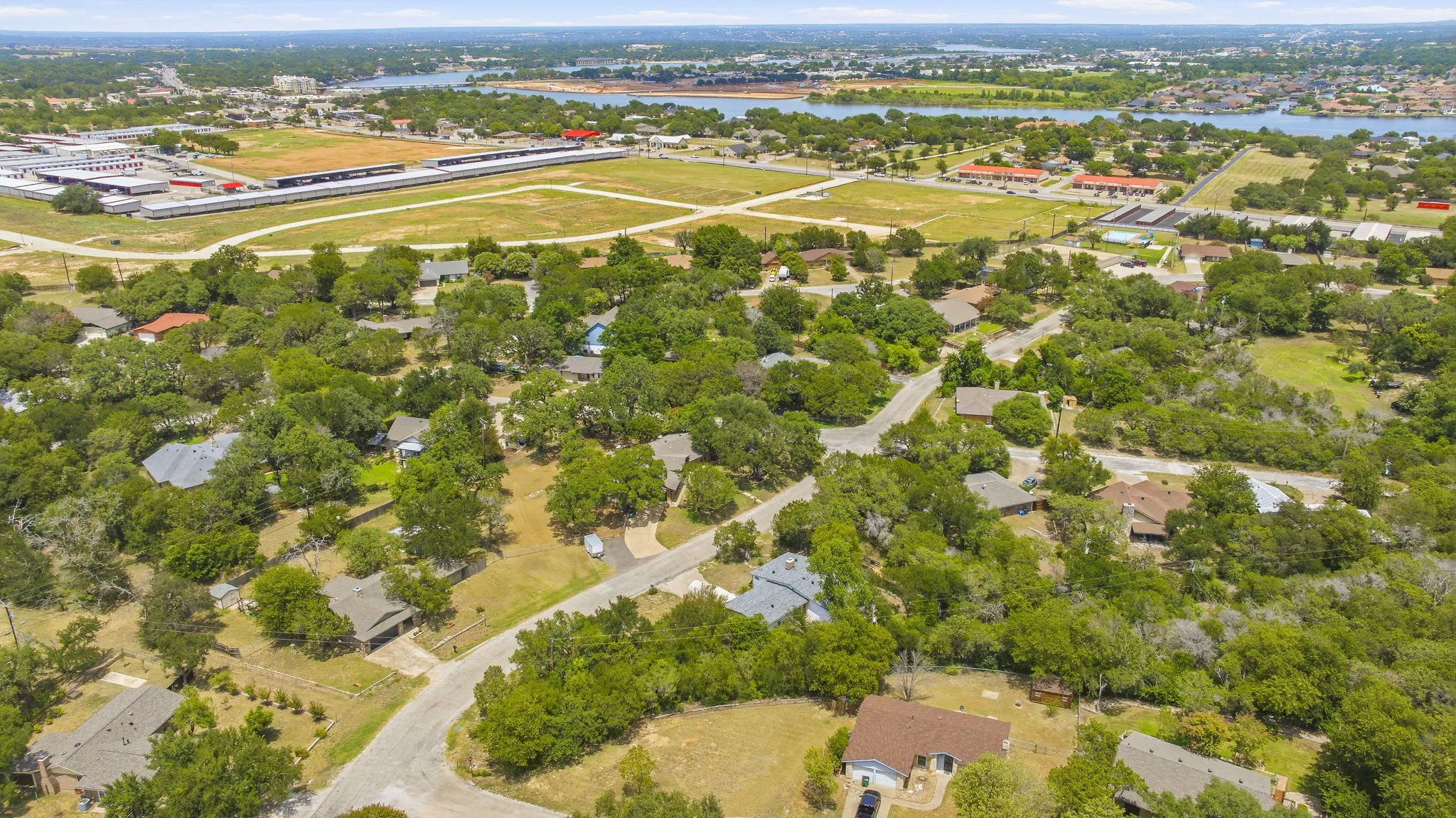 Aerial perspective showcasing a residential area with mature tree coverage