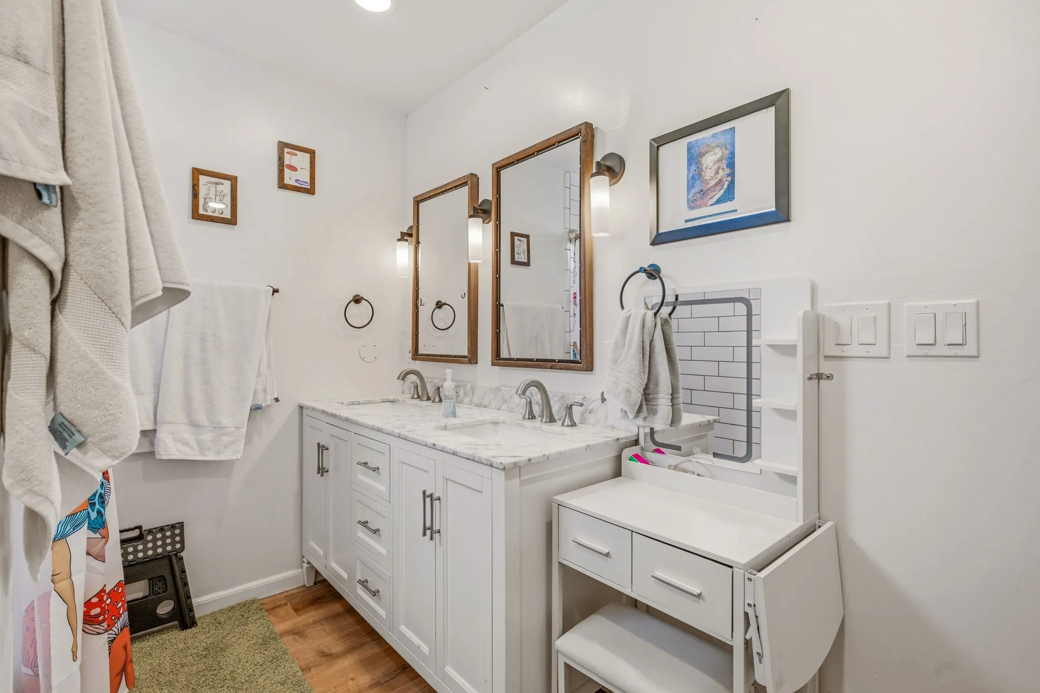 Dual vanity with white cabinetry, granite countertop, and polished chrome fixtures