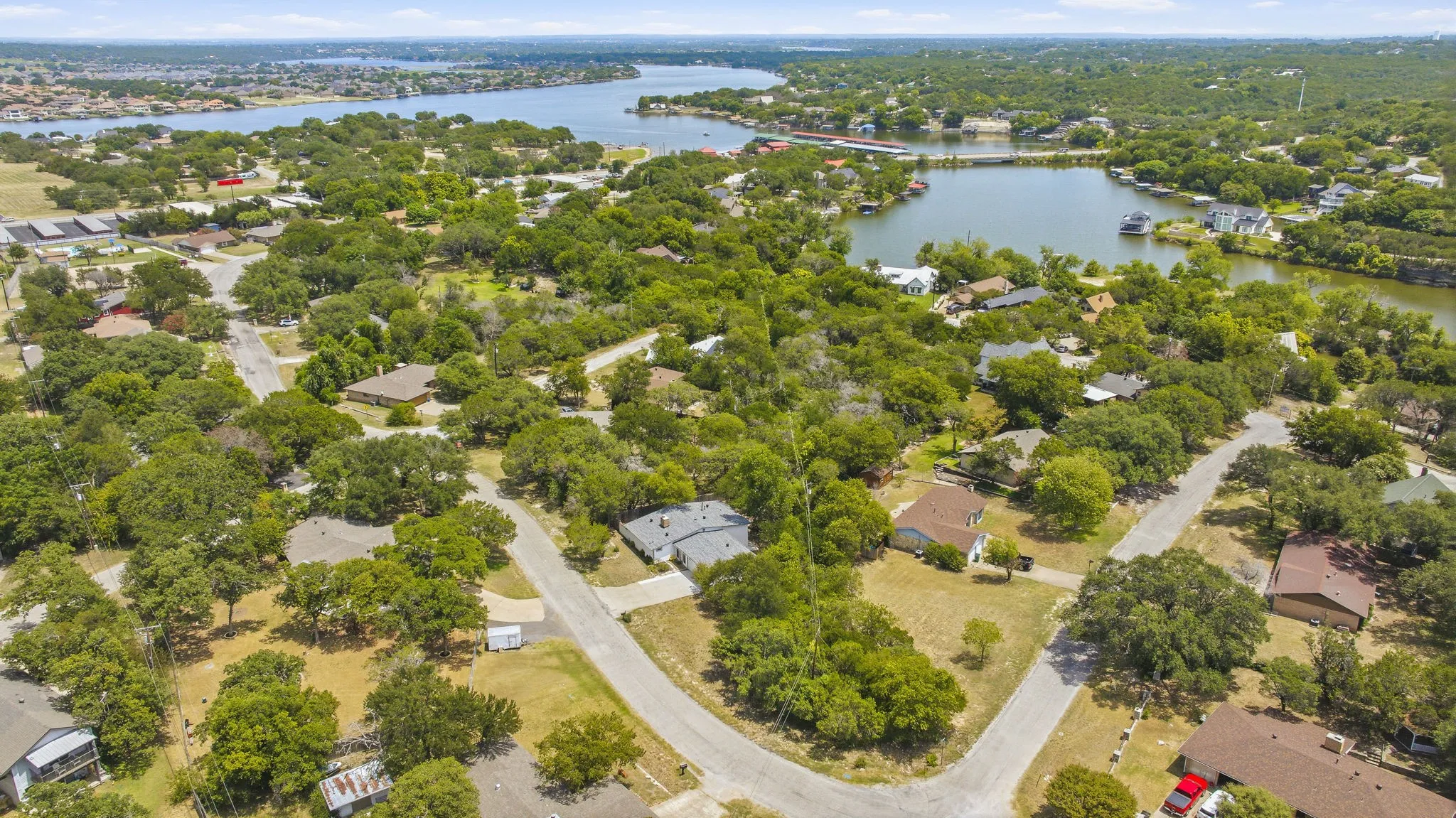 Aerial perspective showcasing a residential area featuring mature trees and established homes