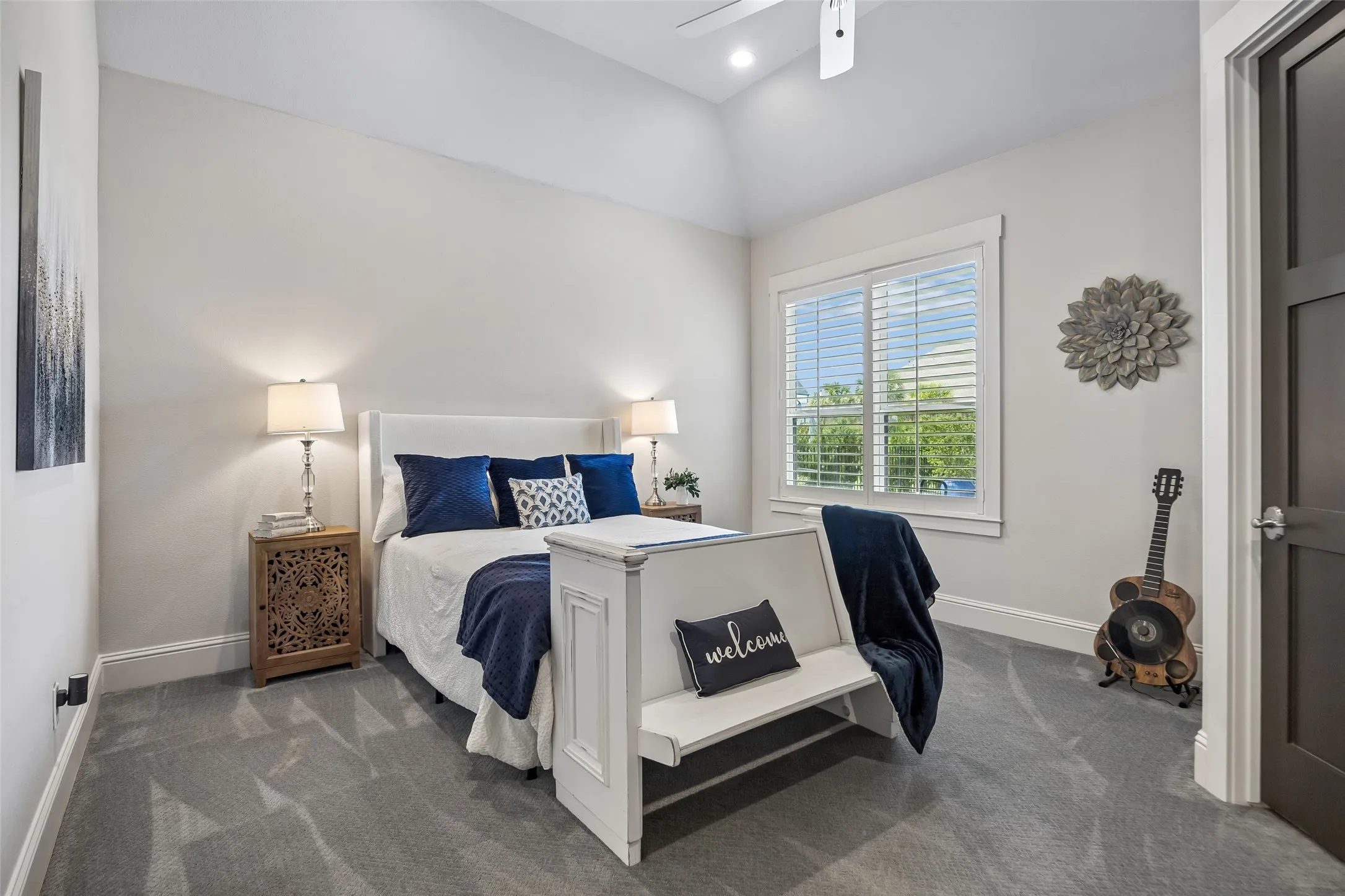 Comfortable  Accommodations with an Ensuite Bath – This well-proportioned bedroom features a vaulted ceiling, a large window, and ample floor space, creating a bright and comfortable private retreat.