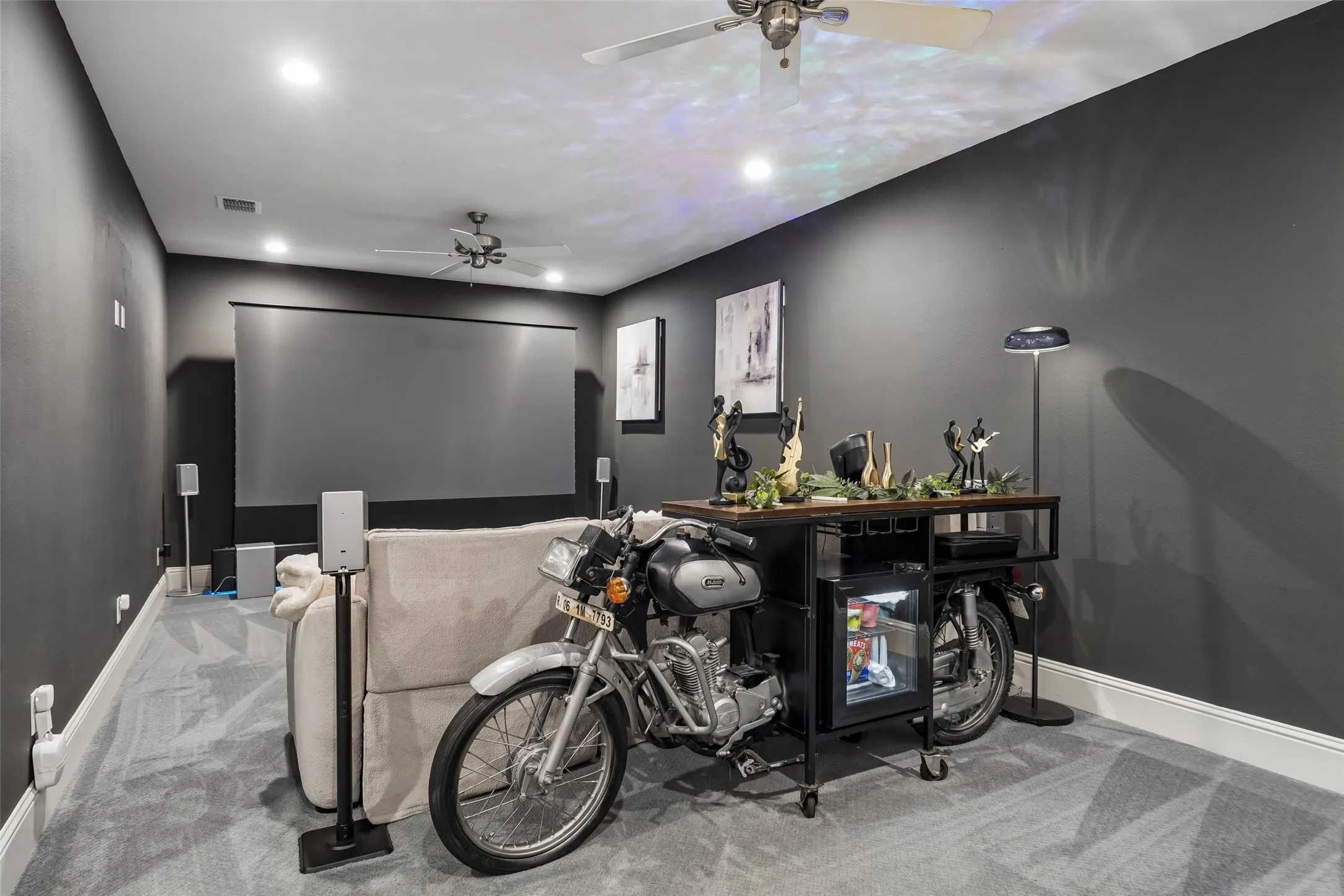 A Private Media Room for Movie Nights – Dark walls and controlled lighting create an immersive setting for films, sports, gaming, and streaming. If you're wanting a more versatile space, there are windows behind the artwork. Screen and speakers are not attached and do not convey.