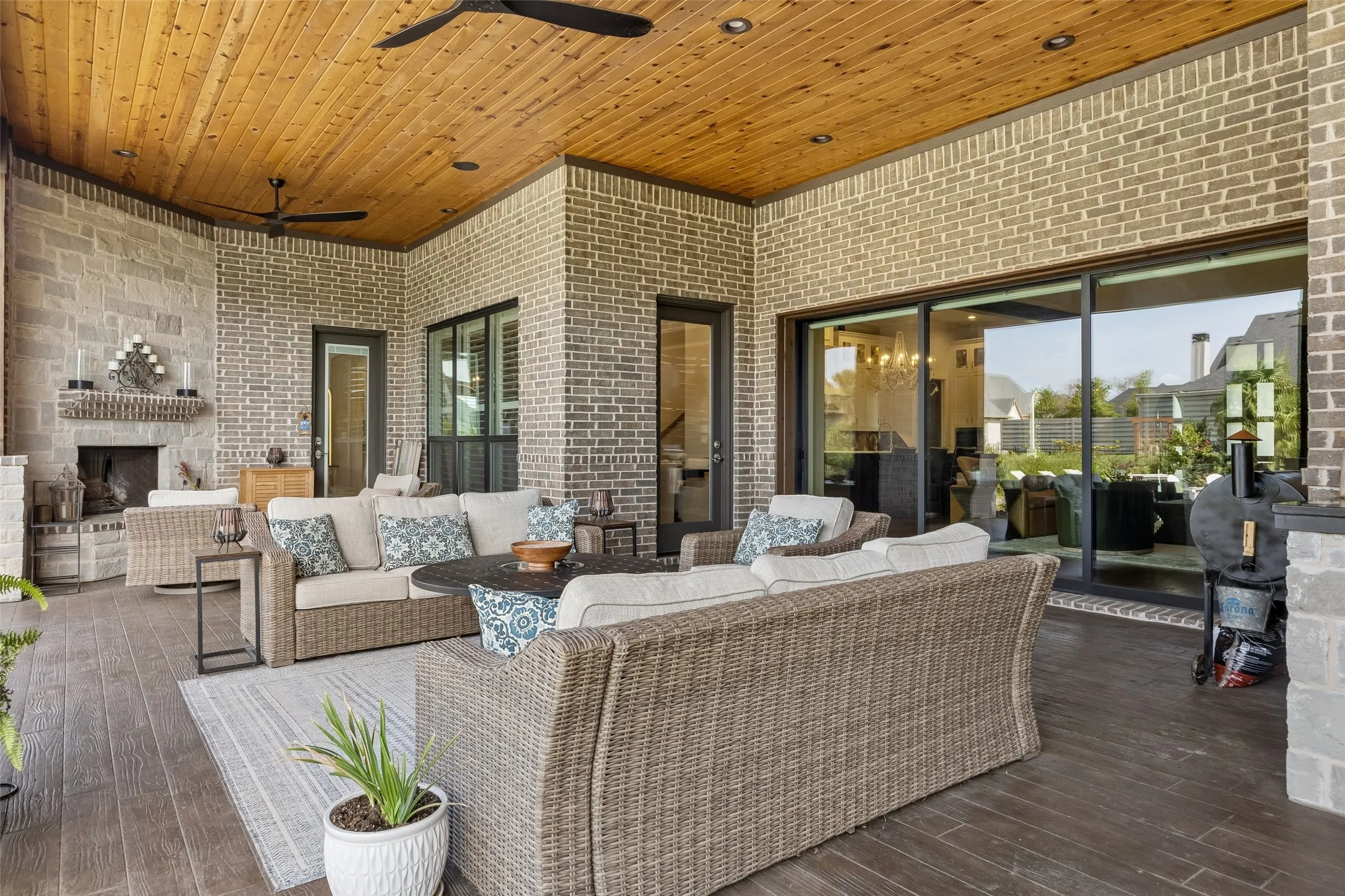 A Fireside Retreat Just Steps from the Pool – The outdoor stone fireplace creates a warm focal point for cooler evenings, while the covered setting keeps the space comfortable and connected to the rest of the backyard.