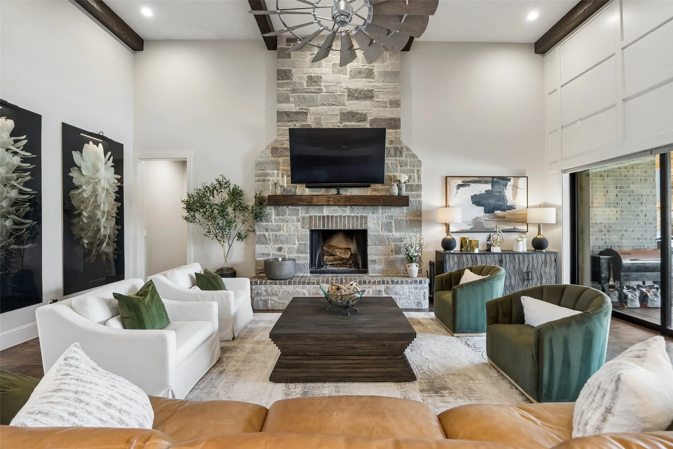 A Great Room Built for the Way You Want to Live – Soaring ceilings, exposed beams, hand-scraped hardwood floors, and a floor-to-ceiling stone fireplace give this room exceptional scale and character. The retractable glass wall opens completely to the covered terrace and pool, turning the family room into a seamless indoor-outdoor gathering space made for relaxed evenings and unforgettable celebrations.