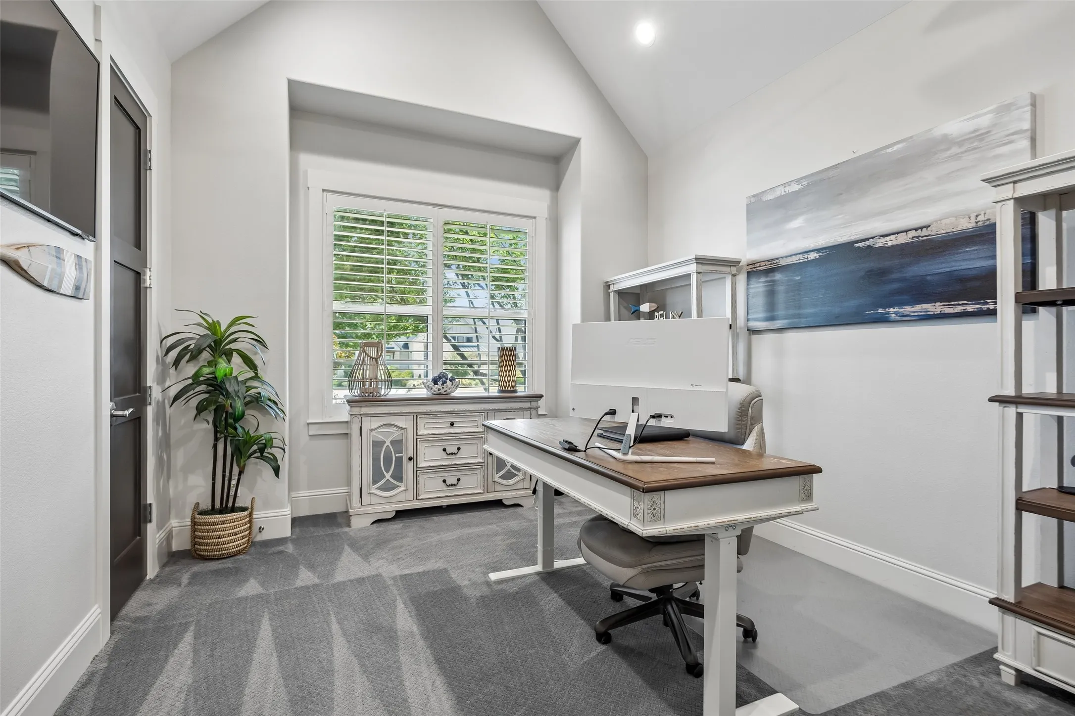 A Flexible Secondary Bedroom – The second of two secondary bedrooms on the first floor, this light-filled room features a vaulted ceiling and the flexibility to serve as a comfortable bedroom, private office, study, or creative space.
