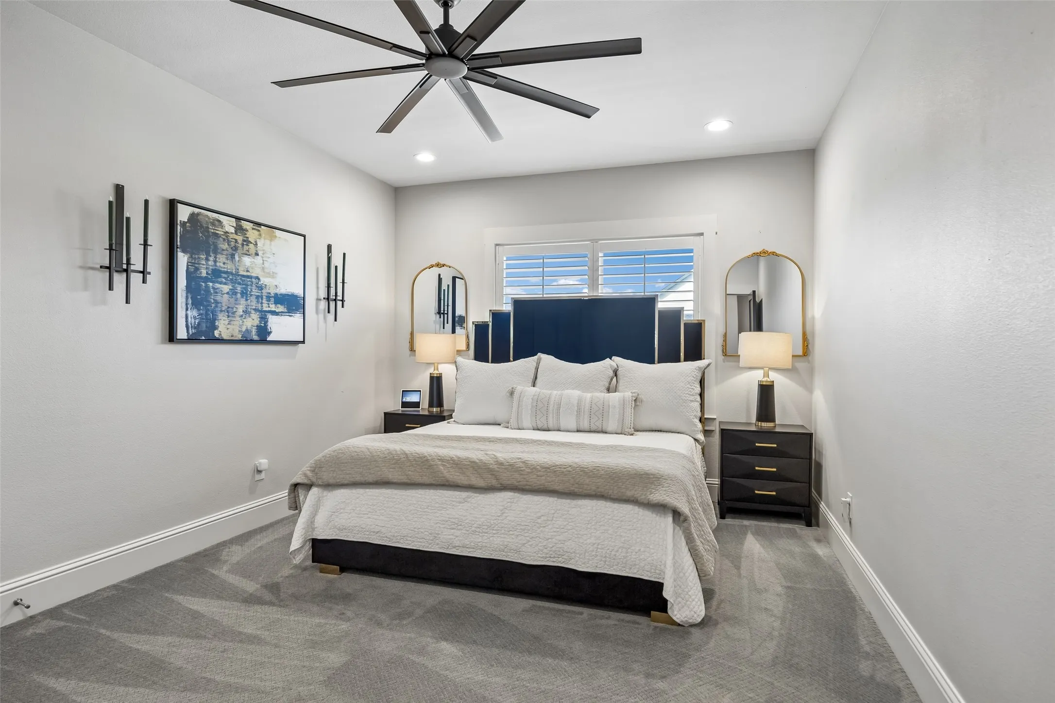 A Comfortable Upstairs Bedroom – This secondary bedroom offers a well-proportioned layout, a wide window, recessed lighting, and enough wall space for flexible furniture placement.