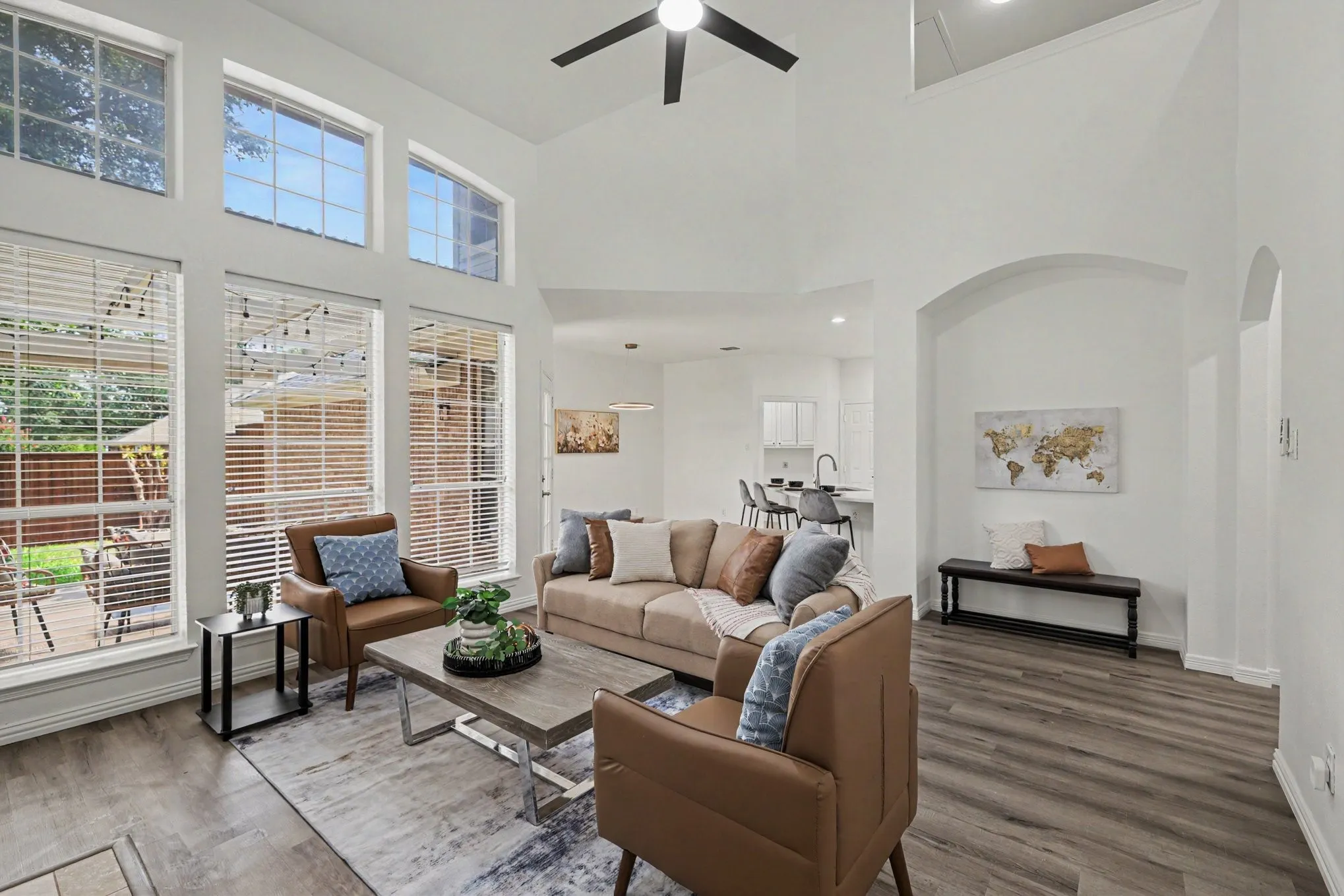 Living area featuring high ceilings, wood-finish flooring, and arched architectural details