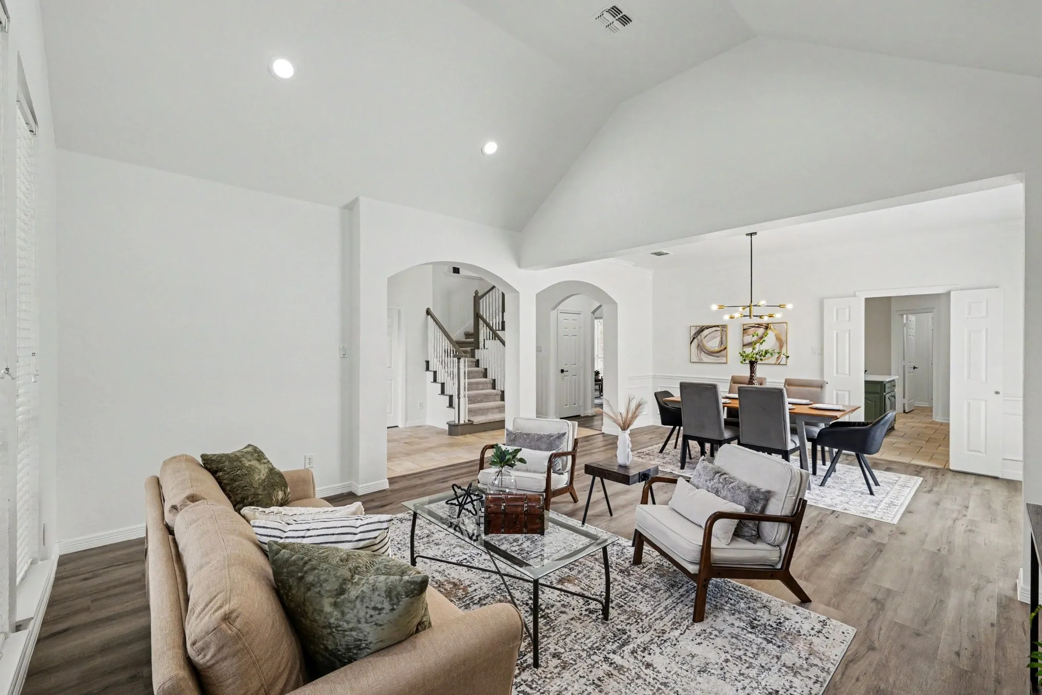 Spacious living area with vaulted ceilings and recessed lighting
