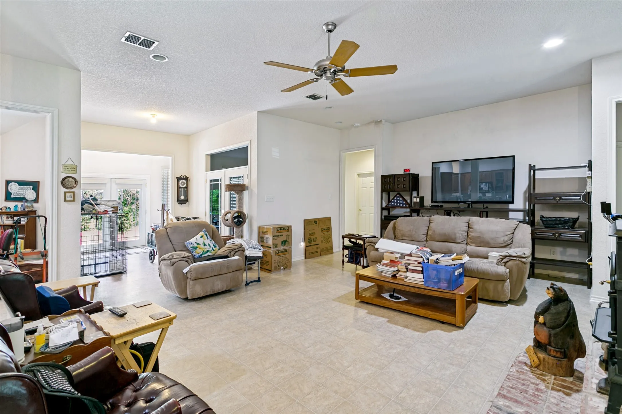 Spacious living area featuring neutral-toned tile flooring throughout