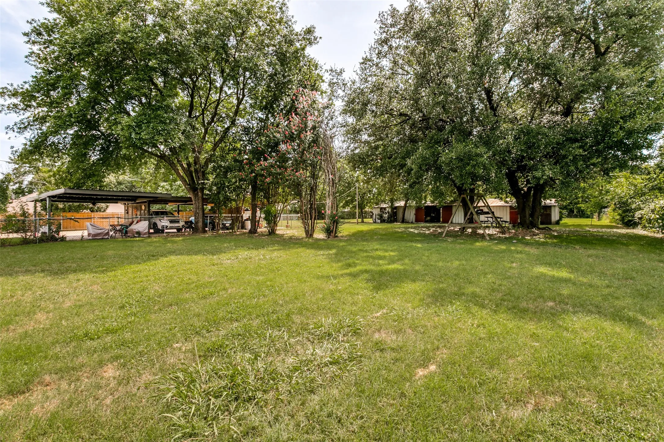 Expansive lawn with mature shade trees