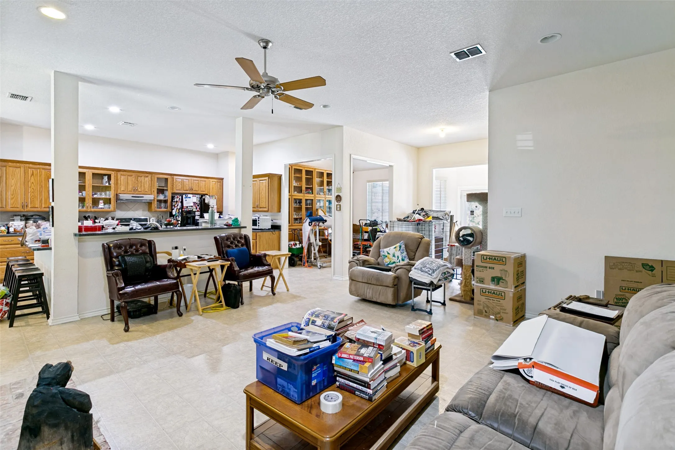 Spacious open-concept interior featuring light-toned flooring and neutral wall finishes
