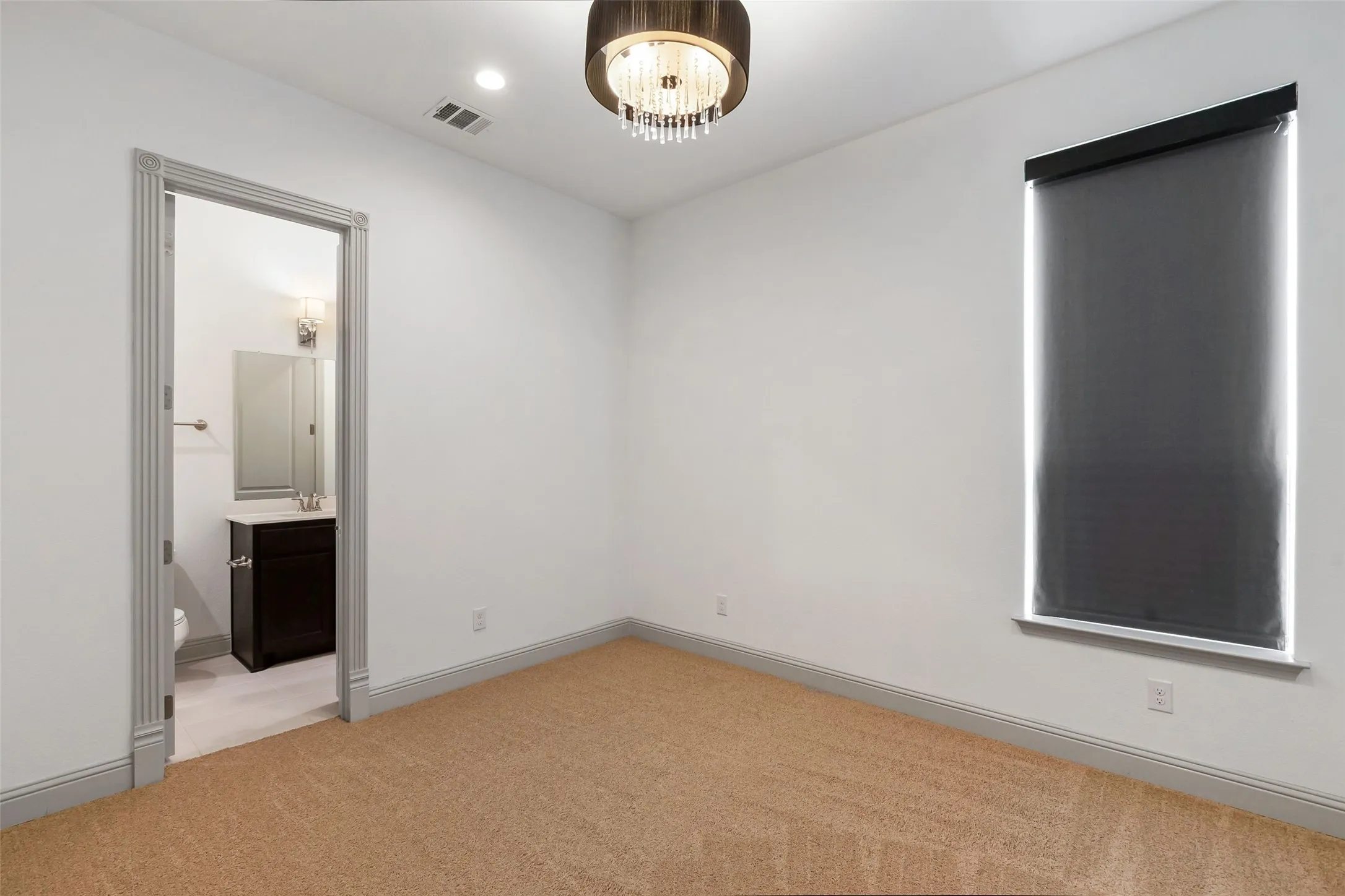 Upstairs guest bedroom with recently installed carpet and an ensuite bathroom