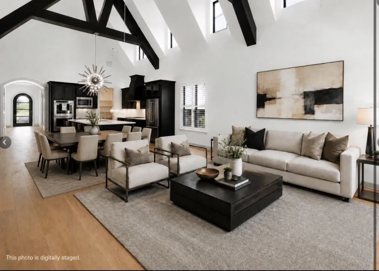 Vaulted ceilings with exposed beams define this open-concept living space