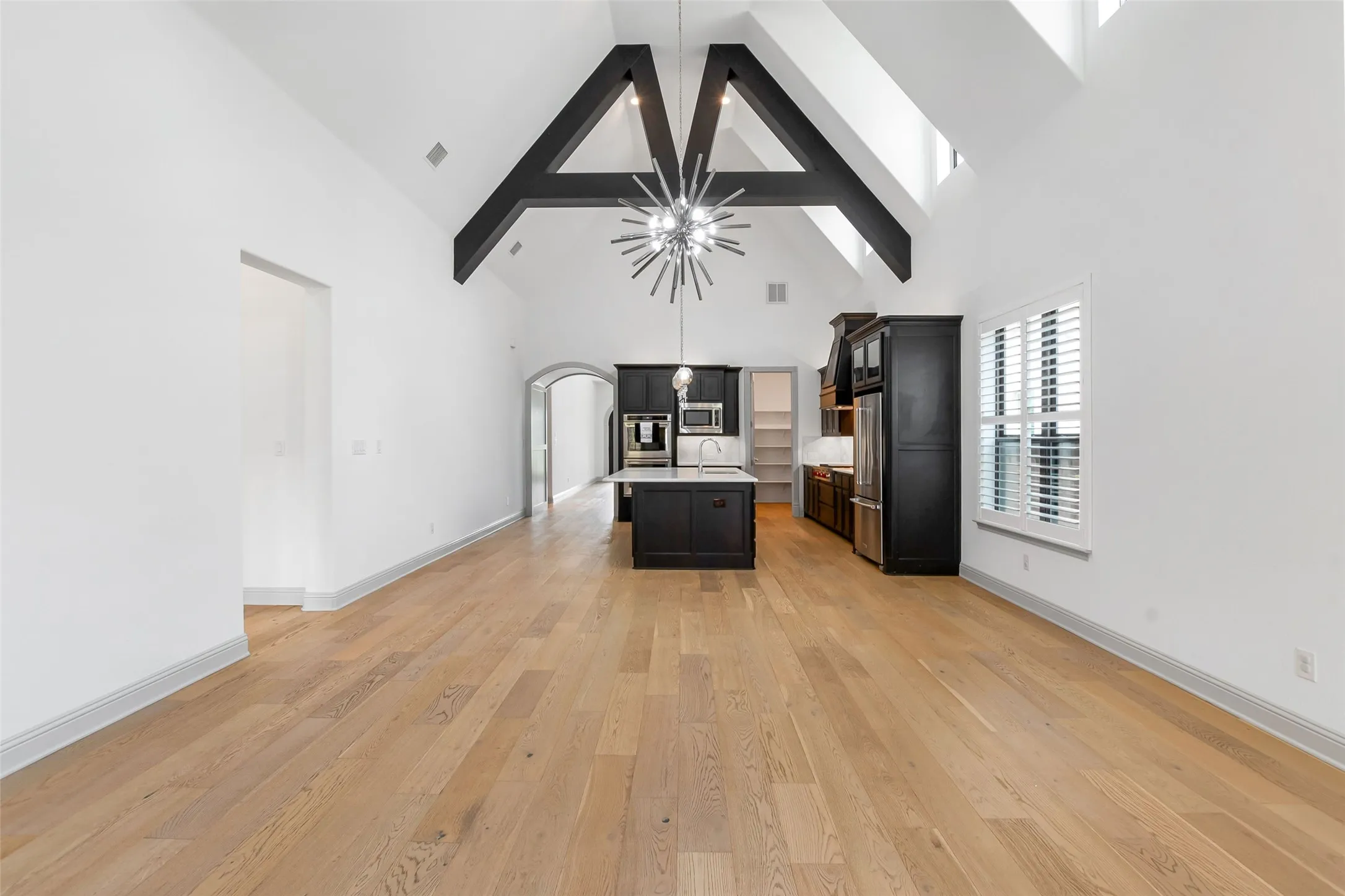 Open concept with cathedral beamed ceilings