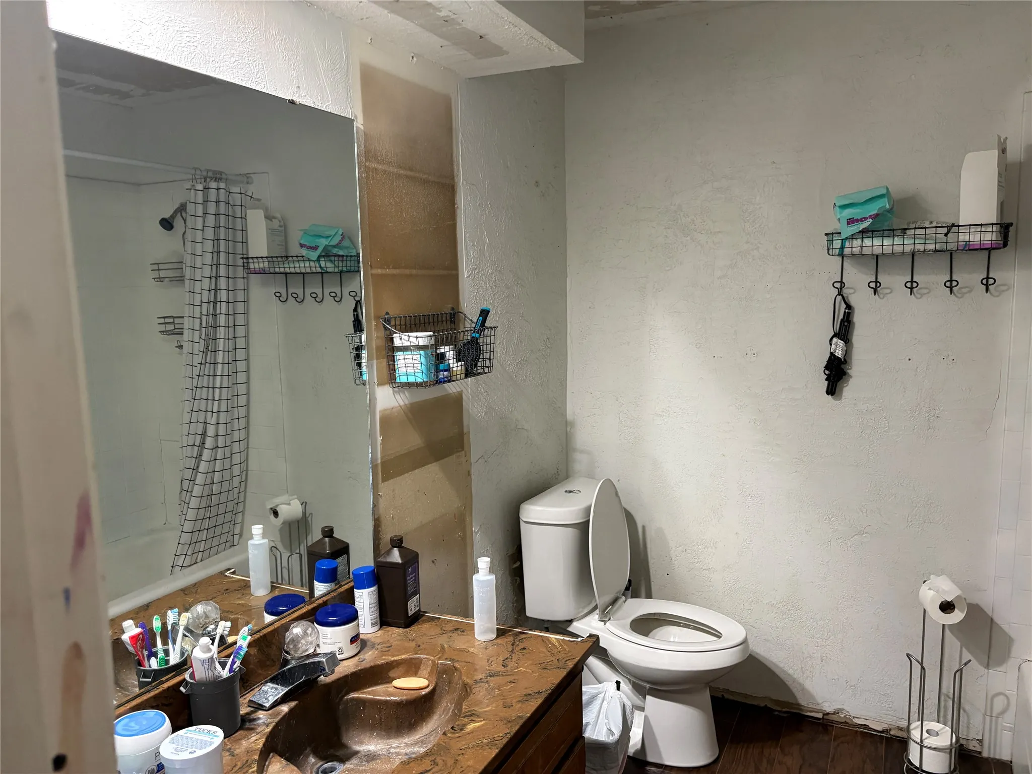 Bathroom featuring a built-in vanity with a stone-finish countertop and an integrated sink